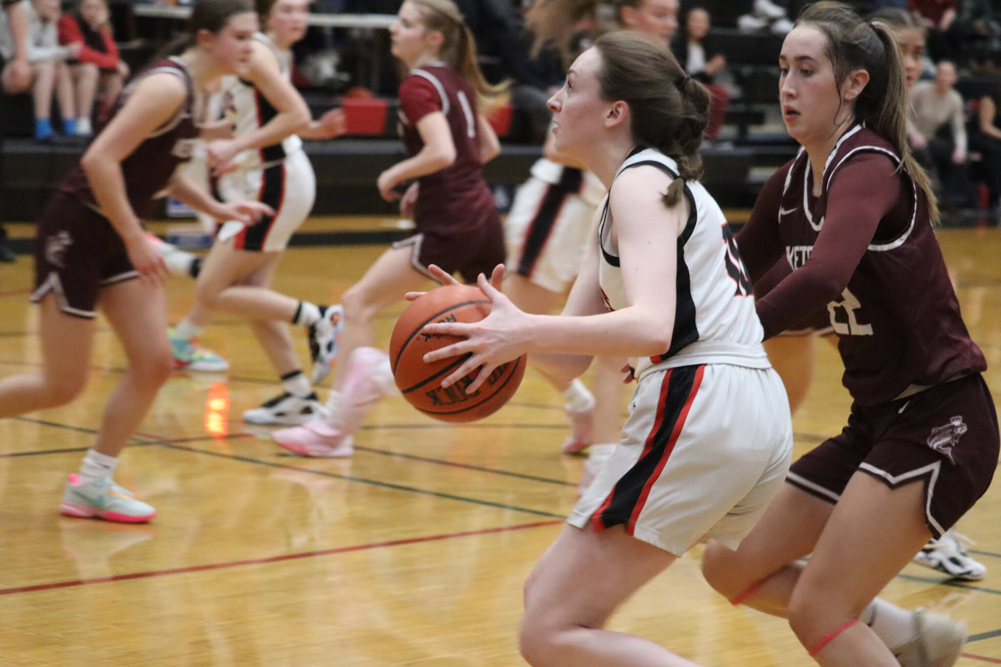 JDHS junior Chloe Casperson takes the ball down court for a layup on Saturday against Ketchikan High School. Casperson would finish the game with a total of 5 points. (Jonson Kuhn / Juneau Empire)