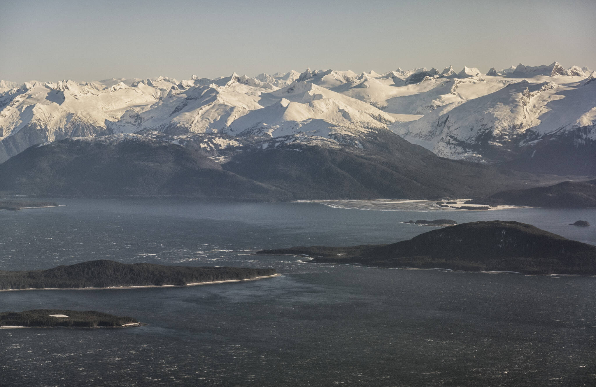 Flying back to Juneau; looking at North Pass between Lincoln Island and Shelter Island, note the white caps (foreground), with Eagle Beach and glacier tucked in between mainland North America mountains. (Courtesy Photo / Kenneth Gill, gillfoto)