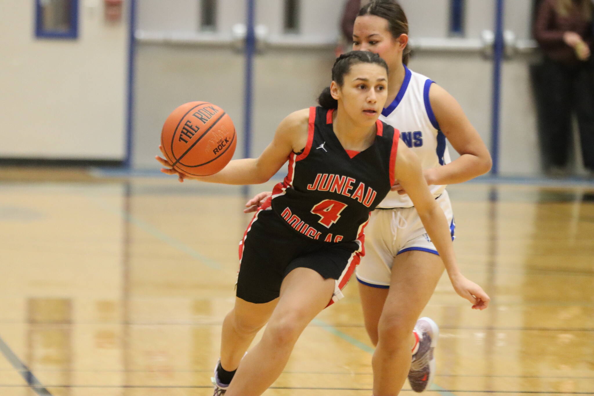 Jonson Kuhn / Juneau Empire 
JDHS senior Kiyara Miller (4) dribbles the ball down court against TMHS on Tuesday night for one of two conference games. Miller tied senior Ashley Laudert for a total of 8 points.