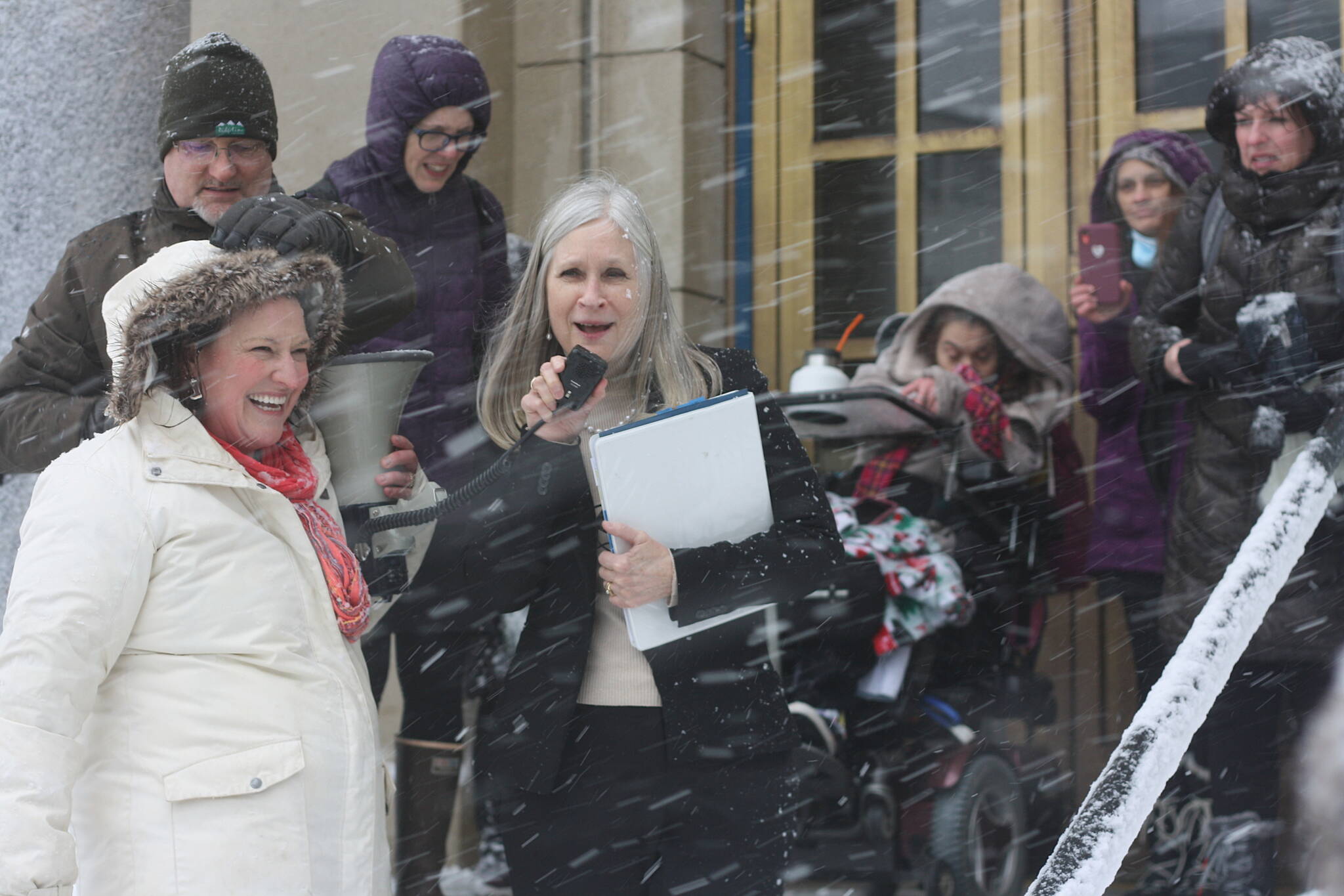 State Rep. Andi Story, D-Juneau, advocates for more state funding on behalf of Alaska residents with disabilities so they can “live as independently as possible” with the help of service providers during a rally in a heavy snowstorm at midday Wednesday on the steps of the Alaska State Capitol. (Mark Sabbatini / Juneau Empire)