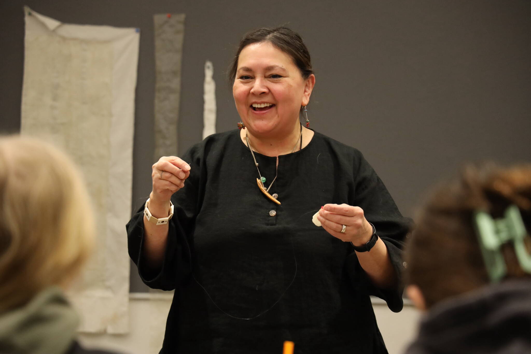 Sonya Kelliher-Combs teaches a youth activity Saturday afternoon where Juneau middle school students were invited to learn how to create a a pouch made from hog intestine and embellished with beads and natural materials. (Clarise Larson / Juneau Empire)