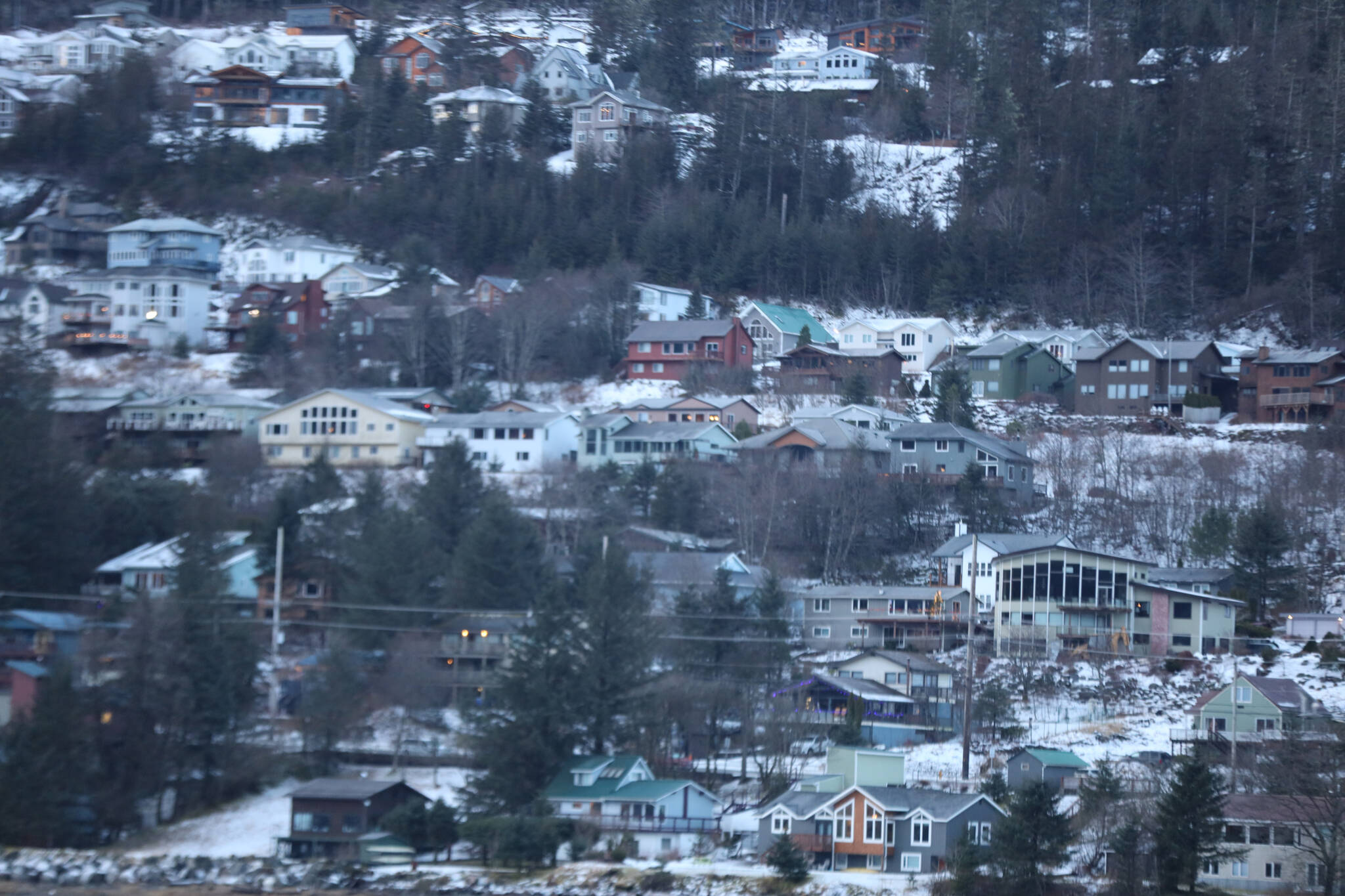 Snows is scattered on the ground between houses on Douglas. The city recently sent out property value notices to Juneau owners, informing them of the annual assessed values of their property. (Clarise Larson / Juneau Empire File)
