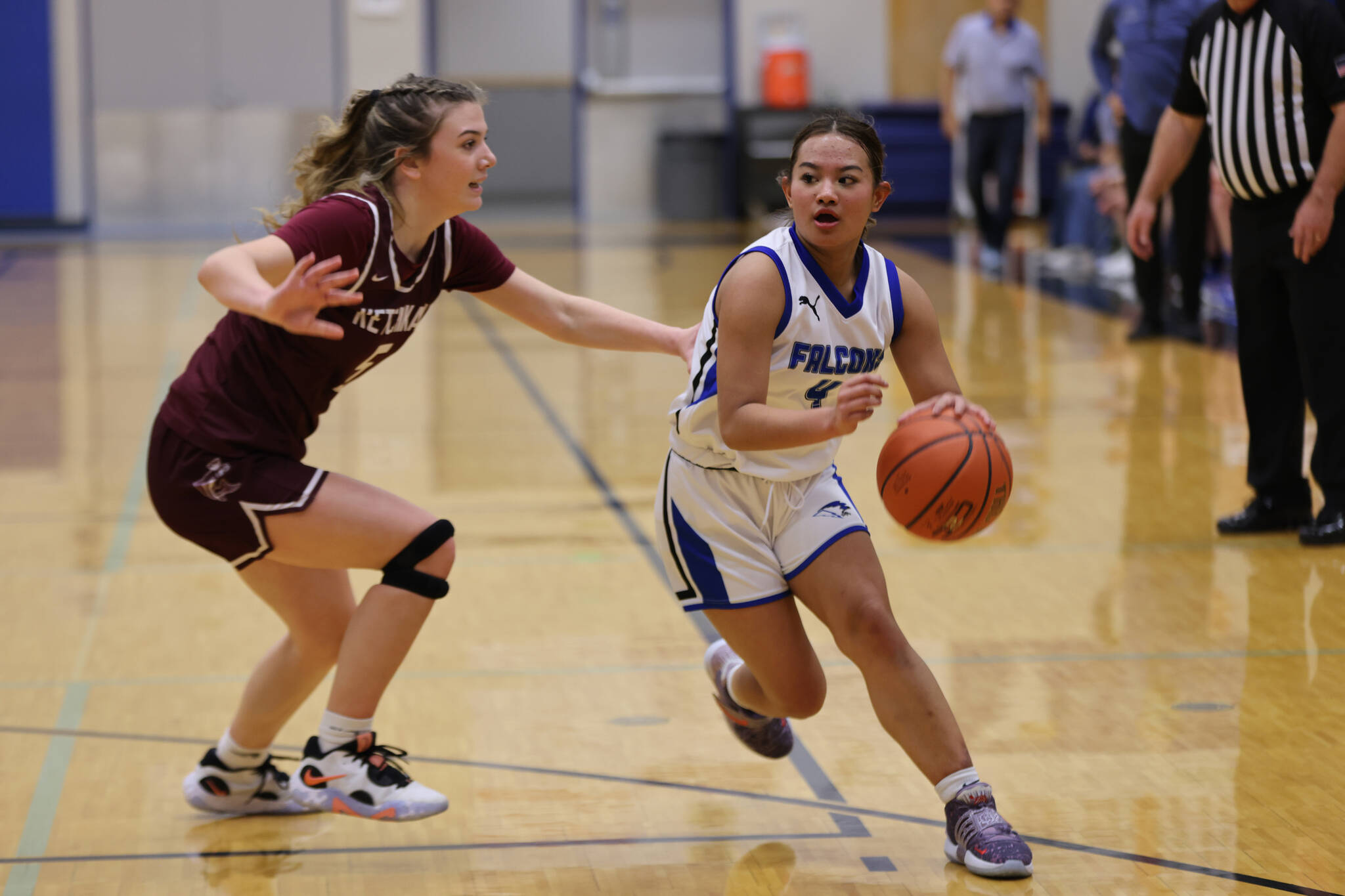 TMHS junior Mikah Carandang takes the ball down court against Ketchikan while defended by Shyla Abajian earlier this season in a conference game at home. (Ben Hohenstatt / Juneau Empire)