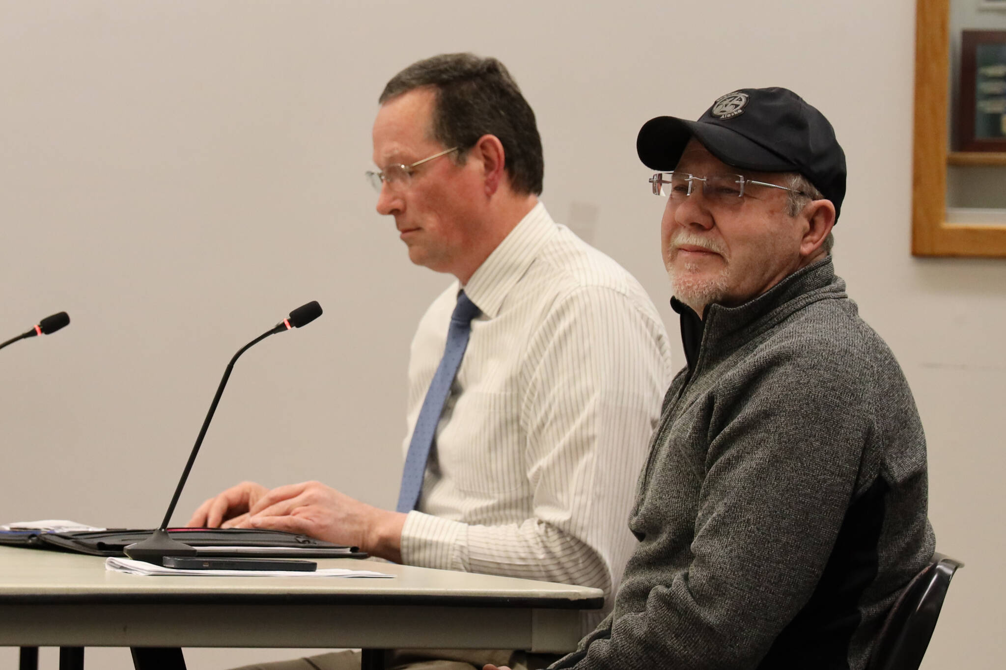 Ride Alaska co-owners James King, left, and Reuben Willis, right, speak to the Assembly meeting as the Committee of the Whole Monday evening to discuss their proposed business venture to bring electric-assisted bicycle tours to West Douglas’ Pioneer Road. (Clarise Larson / Juneau Empire)