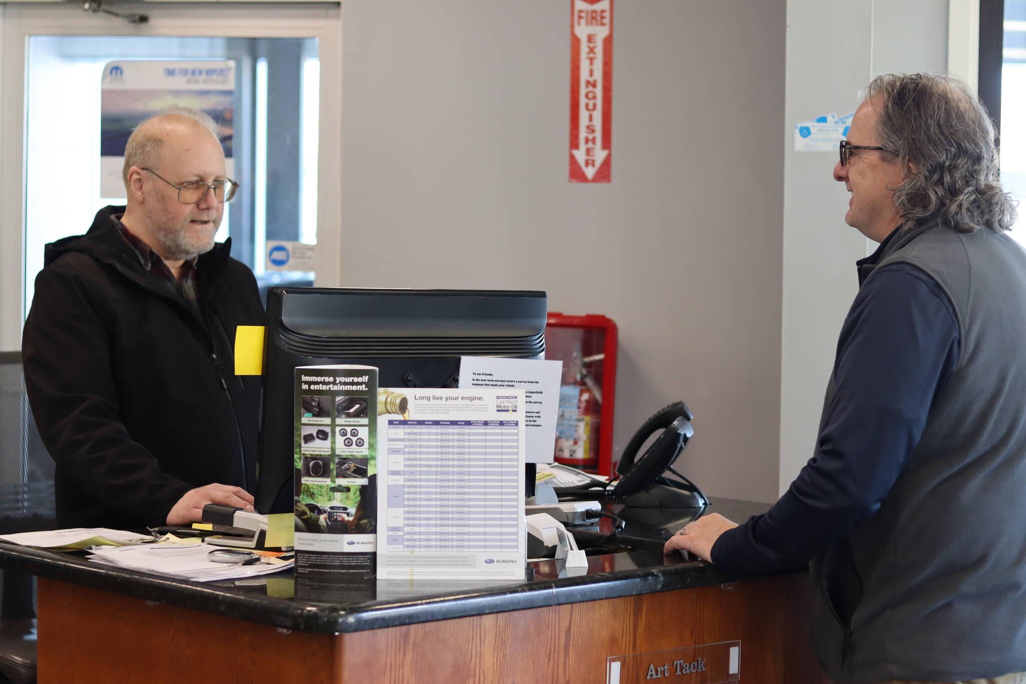Jonson Kuhn / Juneau Empire 
Art Tack helps a customer on Wednesday at the newly named Juneau Auto Mall, which changed hands officially on Wednesday, March 1 from its previous name Mendenhall Auto Center.