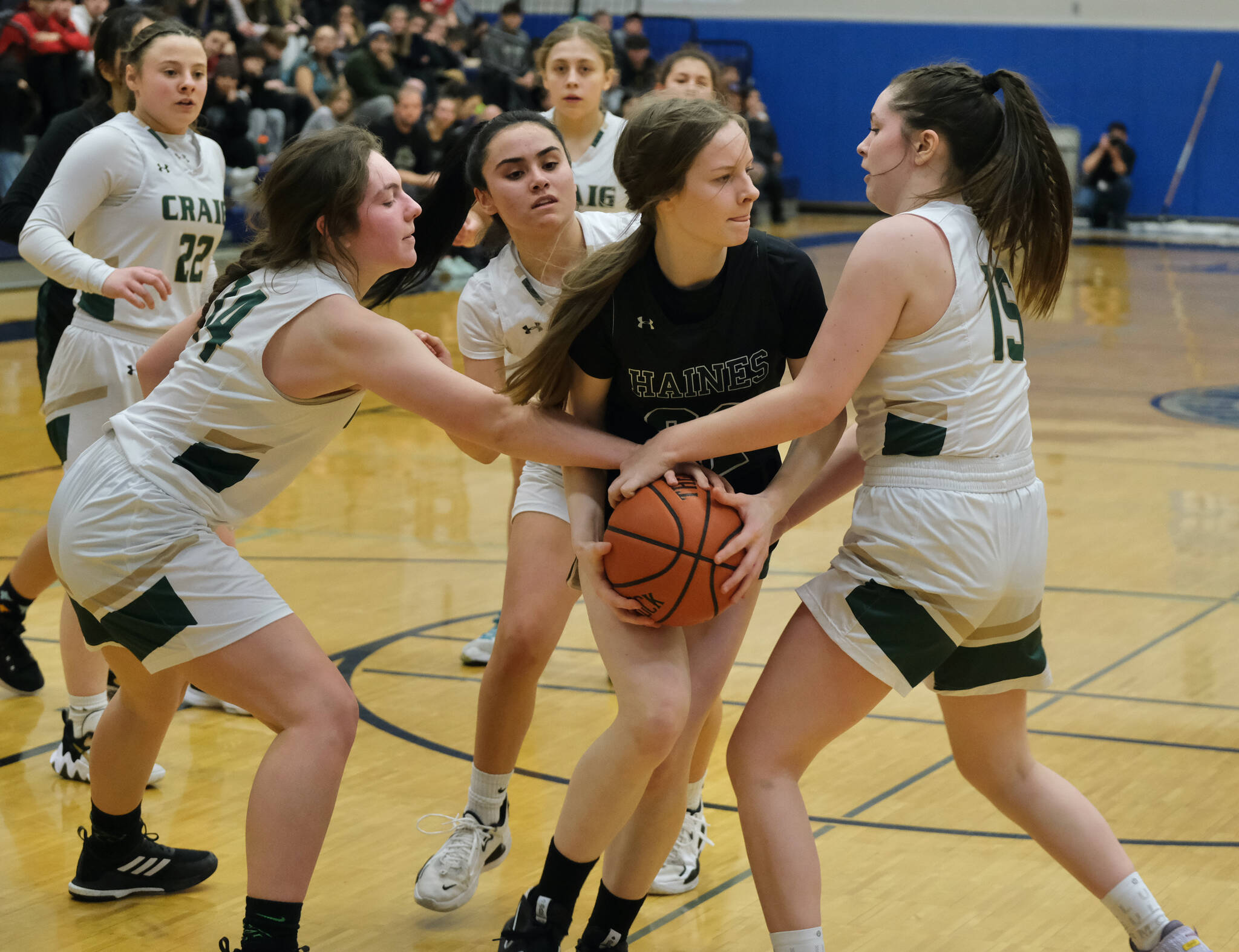 Haines’ Ashlyn Ganey (32) battles for a ball with Craig’s Alissa Durgan (14), Alexis Lawnicki and Amiaya Hansen (15) during Region V tournament action on Wednesday. (Klas Stolpe / For the Juneau Empire)