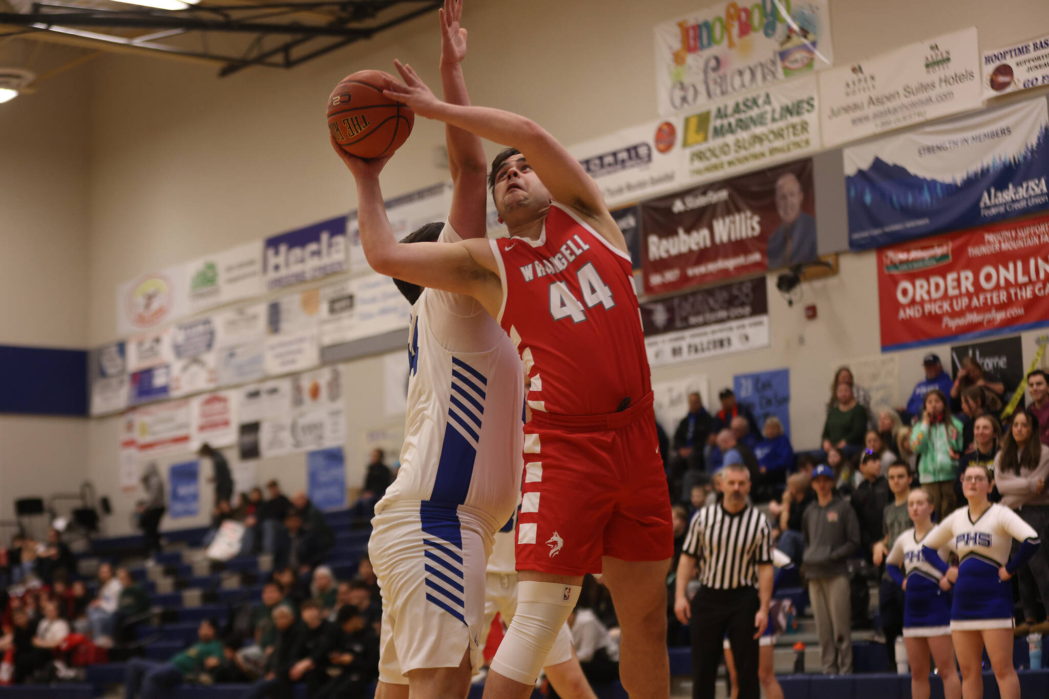 Wrangell senior Leroy Wynne (44) works around his defender to take a shot at the hoop in the first half of a Region V loss to Petersburg. (Ben Hohenstatt / Juneau Empire)