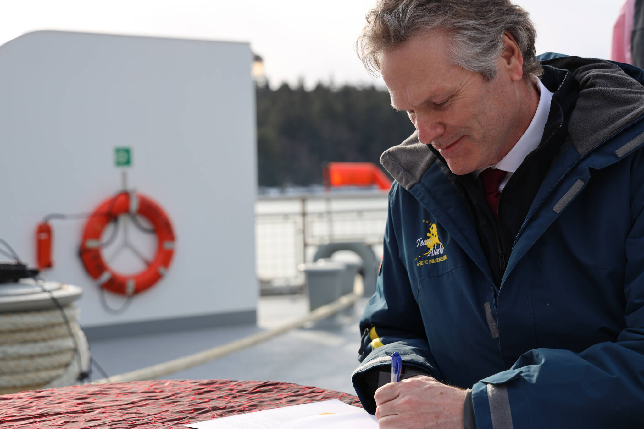Gov. Mike Dunleavy signs a memorandum of understanding Thursday afternoon between the Alaska Department of Transportation and Public Facilities and Goldbelt Inc. to pursue engineering and design services to determine whether it’s feasible to build a new ferry terminal facility in Juneau at Cascade Point. (Clarise Larson / Juneau Empire)
