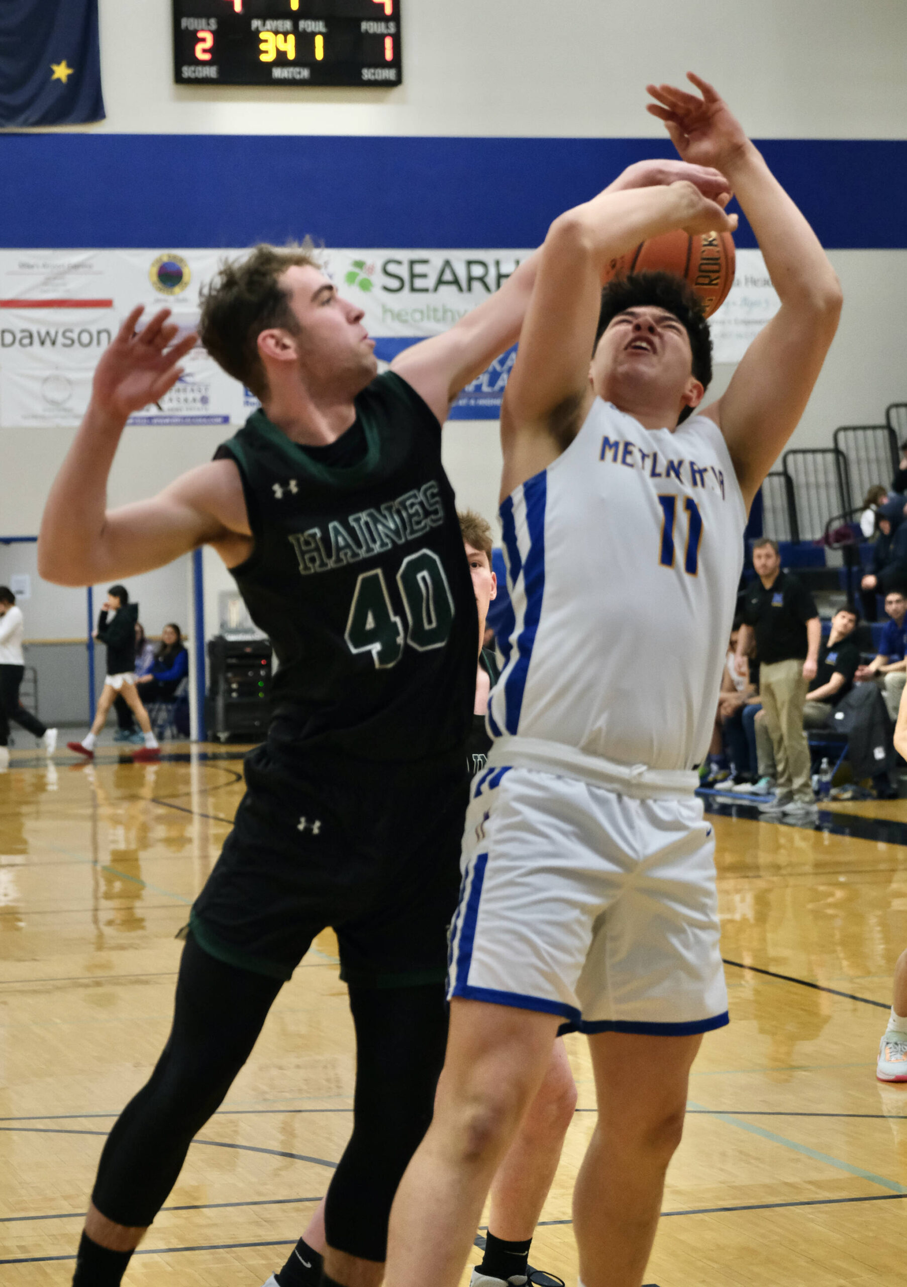 Haines senior Eric Brouilette (40) blocks a shot by Metlakatla senior TJ Jackson (11) during the Region V 2A/4A Basketball Tournament on Thursday at Thunder Mountain High School in Juneau. (Klas Stolpe / For the Juneau Empire)