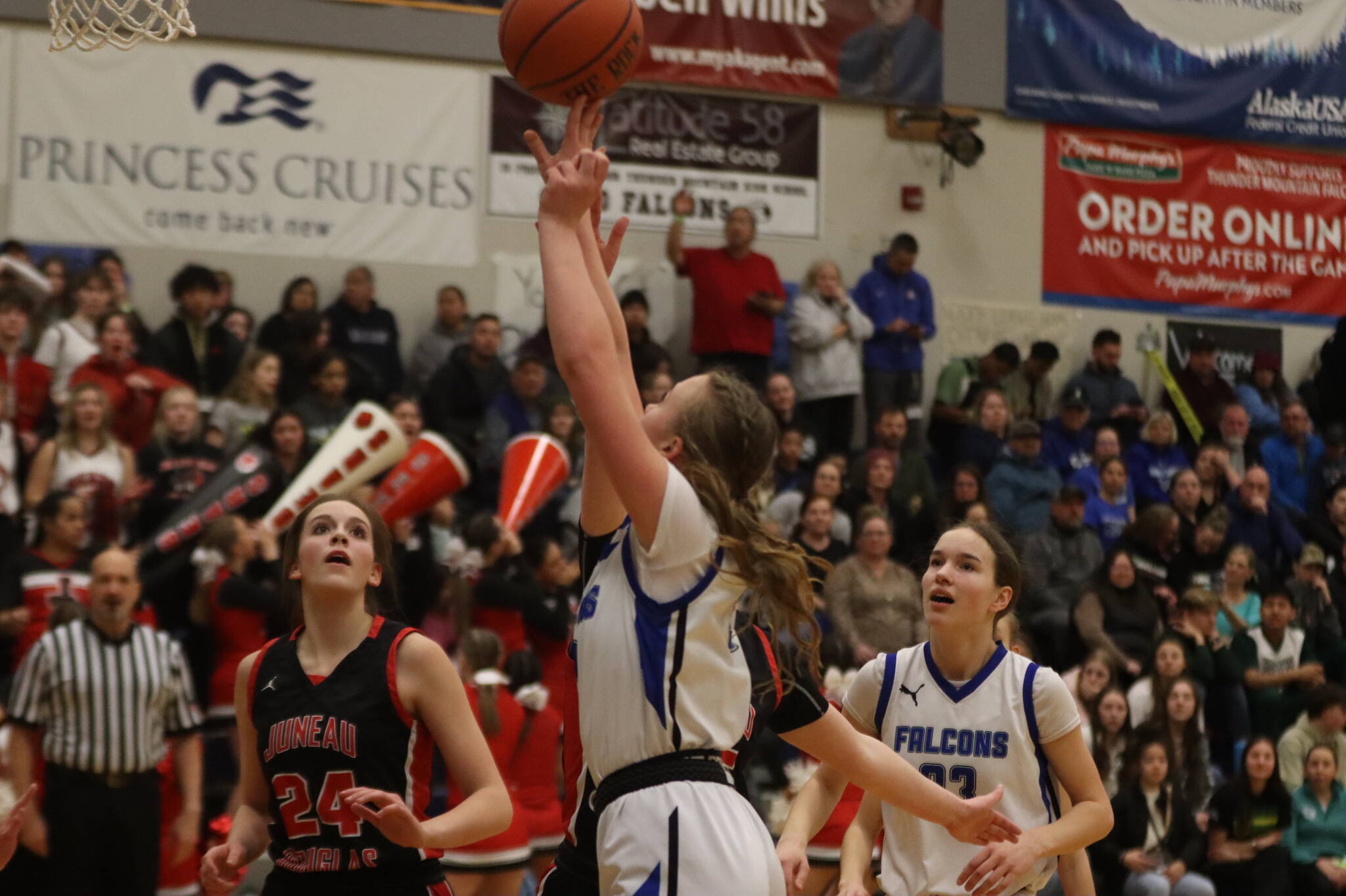 TMHS Ashlyn Gates takes the ball in for a layup against JDHS on Thursday during their second 4A game of the Region V tournament at TMHS. (Jonson Kuhn / Juneau Empire)
