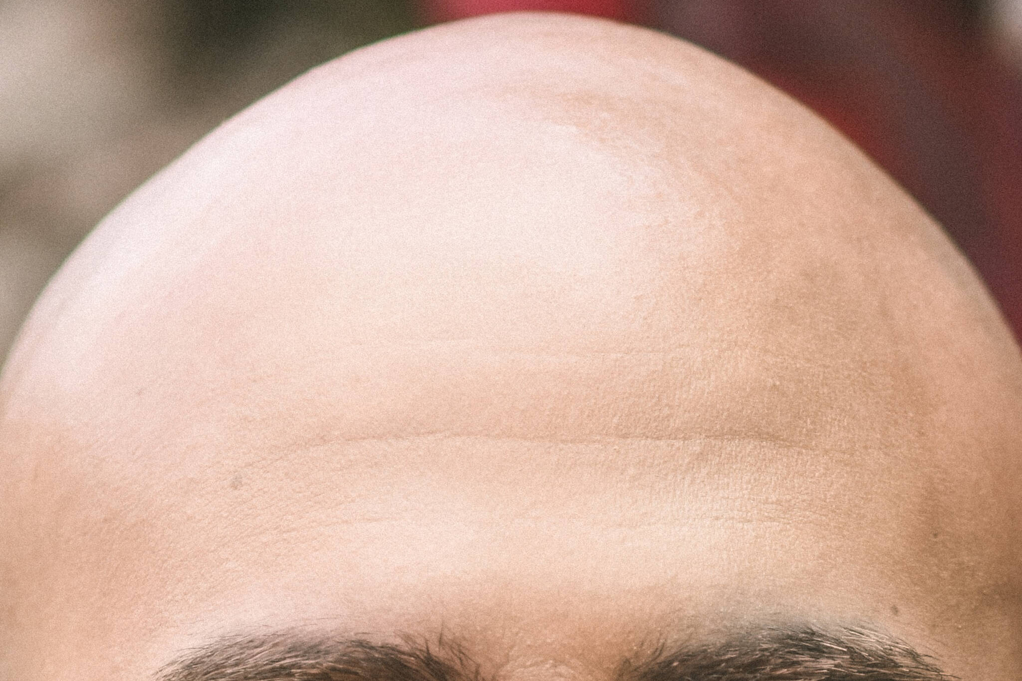 "Bald pride abounds," writes Geoff Kirsch. "In fact, a Bald Men Club of Japan holds an annual Bald Man Competition. In this Olympic-style international tournament, two men stick suction cups to their heads, attached to a single red rope, and then attempt to pull off their opponent’s cup, tug-of-war style. Better start training for next year; I wonder what the rules say about Spider Tack…" (Unsplash /  Chalo Garcia)