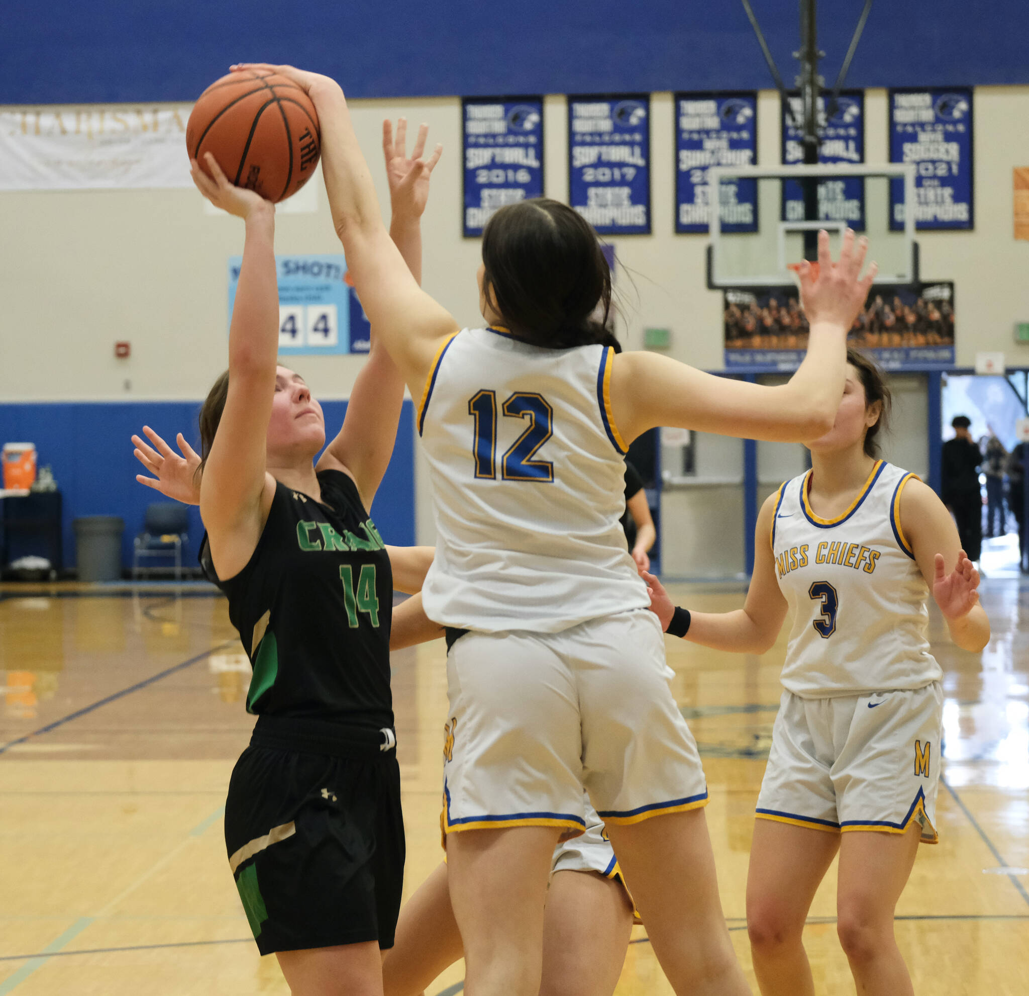 Metlakatla High School sophomore Lexi Cook (12) blocks a shot by Craig senior Alissa Durgan (14)  during the MisChiefs 2A Region V Championship game win over the Lady Panthers on Friday at Juneau's Thunder Mountain High School. (Klas Stolpe  / for the Juneau Empire)