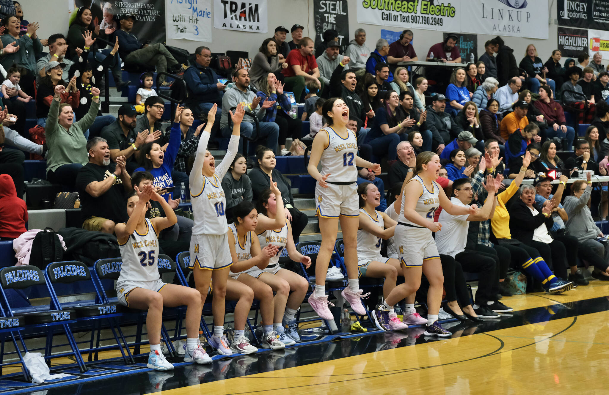 Metlakatla MisChiefs players celebrate a made basket during their 47-18 win over the Craig Lady Panthers in the 2A Region V Championship Game at Juneau’s Thunder Mountain High School on Friday. (Klas Stolpe / For the Juneau Empire)