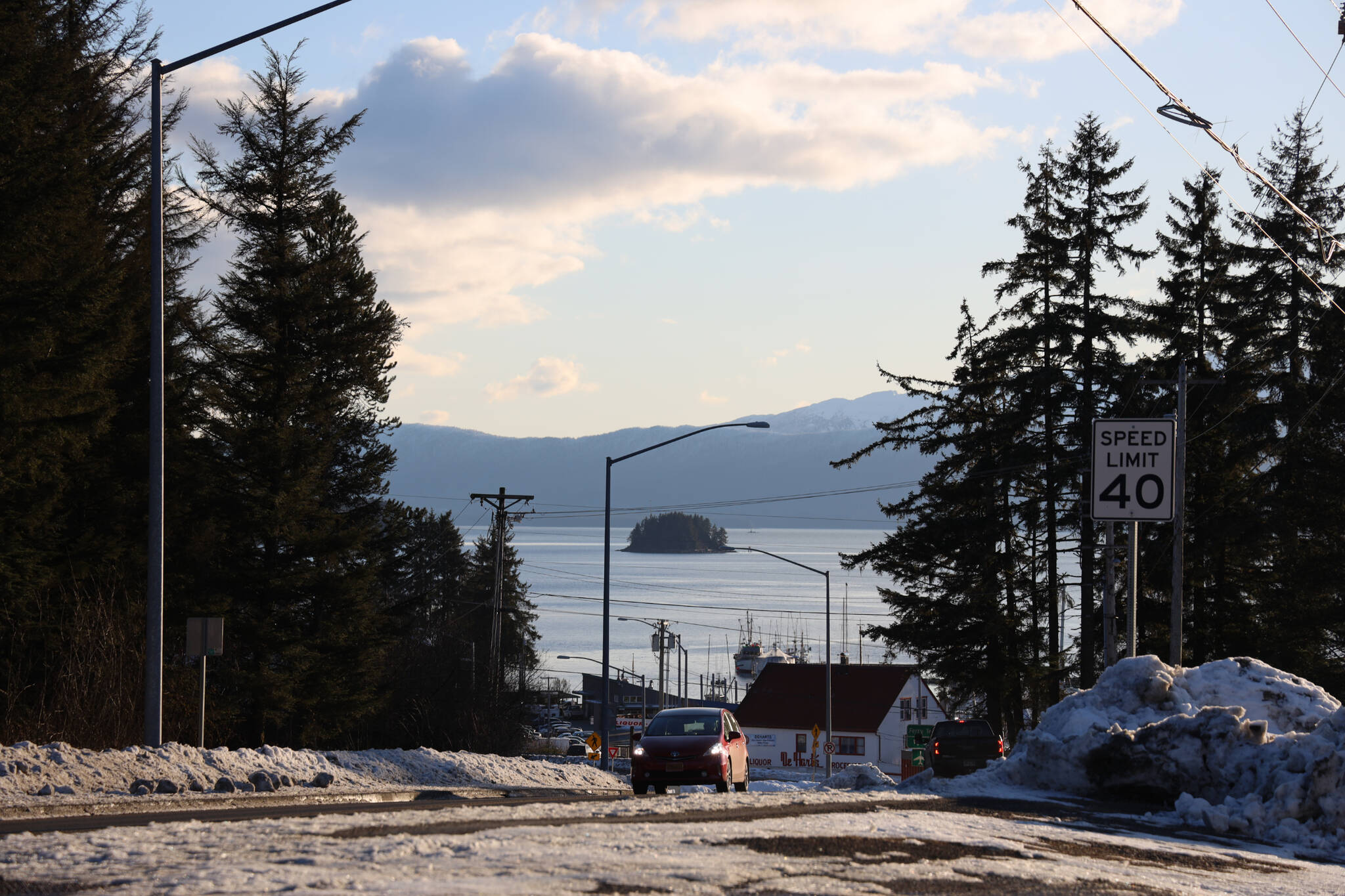A car drives up a hill near Auke Bay in early March. Transportation was a popular topic in a recent draft report that found lower greenhouse gas emissions in Juneau when comparing 2010 to 2021. (Clarise Larson / Juneau Empire)