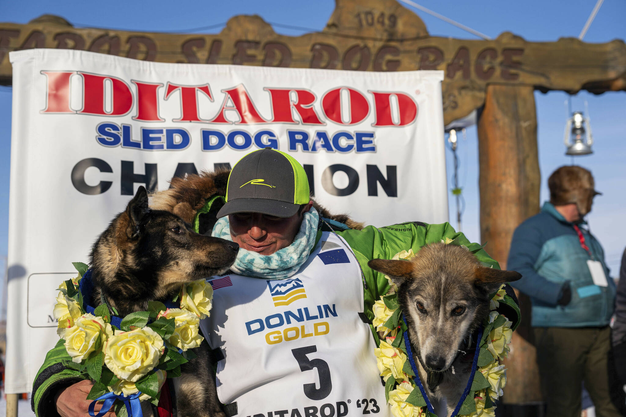 Ryan Redington poses with his lead dogs Sven, left, and Ghost, after he won the 2023 Iditarod Trail Sled Dog Race, Tuesday, March 14, 2023 in Nome, Alaska. Redington, 40, is the grandson of Joe Redington Sr., who helped co-found the arduous race across Alaska that was first held in 1973 and is known as the “Father of the Iditarod.”  (Loren Holmes / Anchorage Daily News)