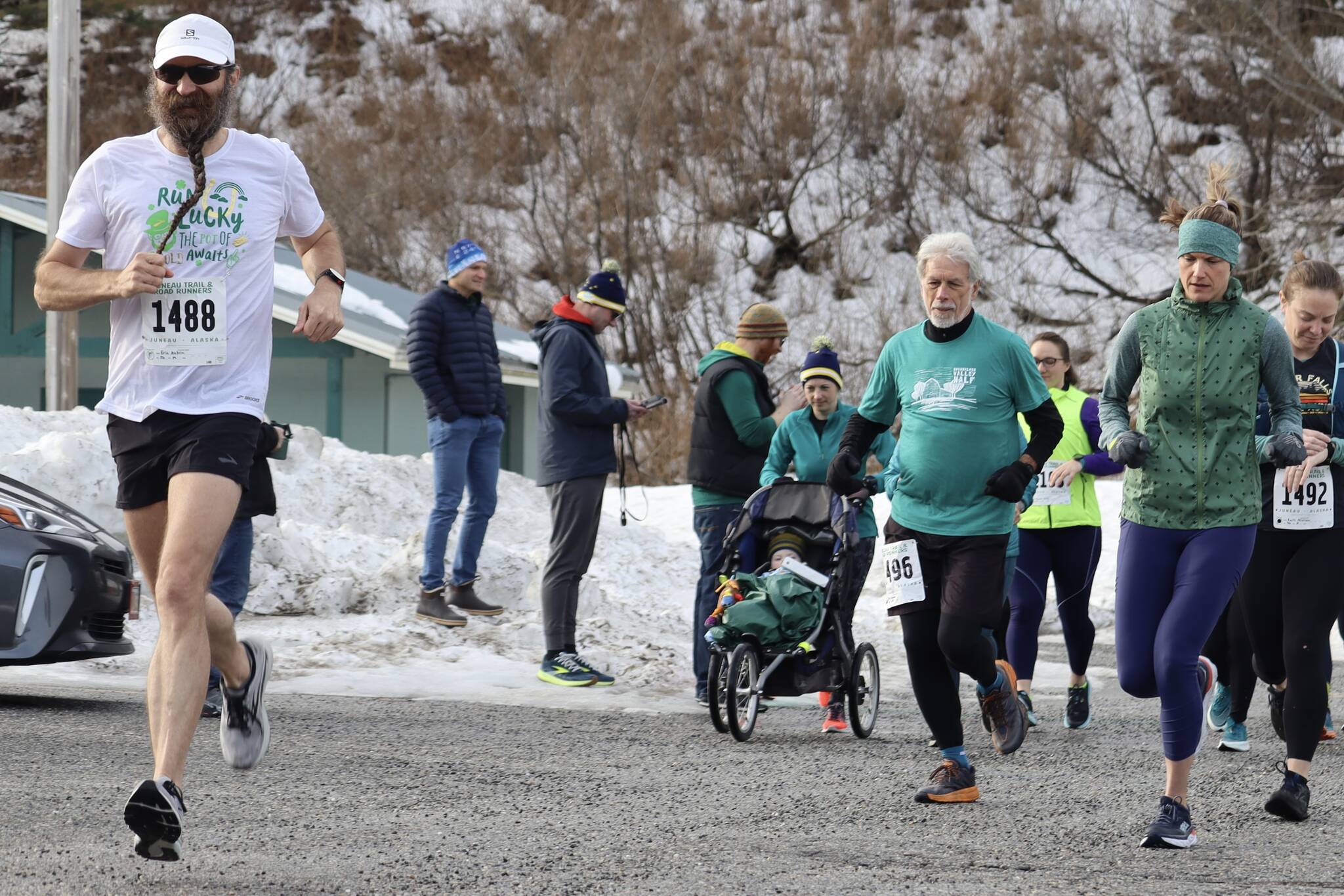 Eric Antrim (1488) leads the pack on Saturday for JTRR’s annual Flanagan’s Run at Savikko Park. Antrim would later finish the 5-mile option of the race first with a finish time of 34:07. (Jonson Kuhn / Juneau Empire)