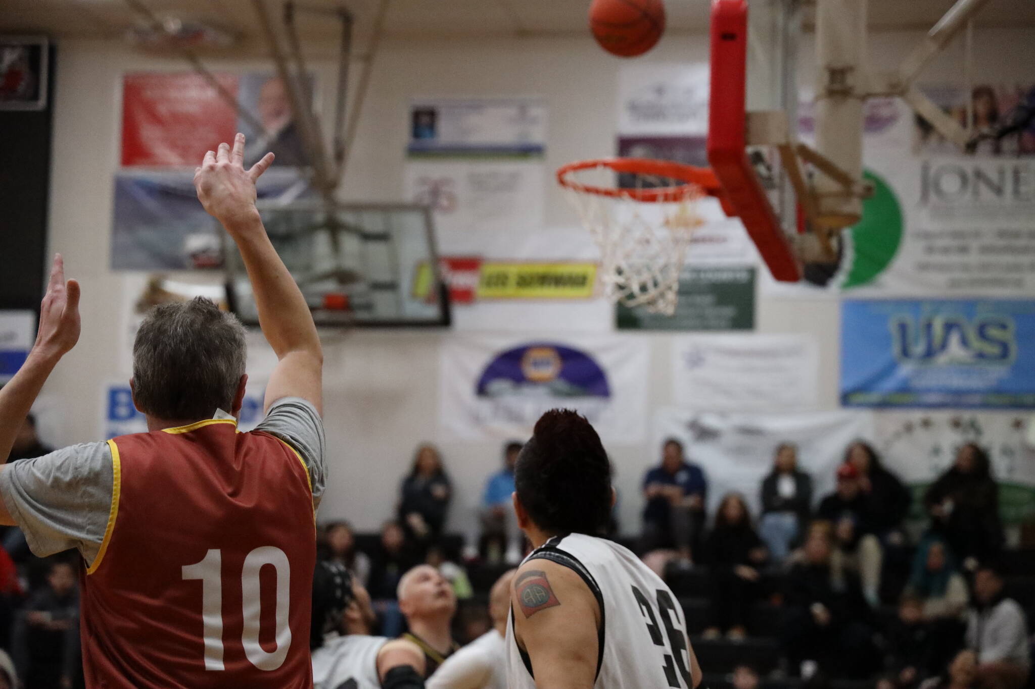 Juneau’s Gold Medal Tournament Masters Bracket basketball team’s Will Whitehead secures a two-point shot early on in the first quarter of a game against Angoon Sunday afternoon a part 74th Juneau Lions Club Gold Medal Basketball Tournament. Clarise Larson / Juneau Empire)