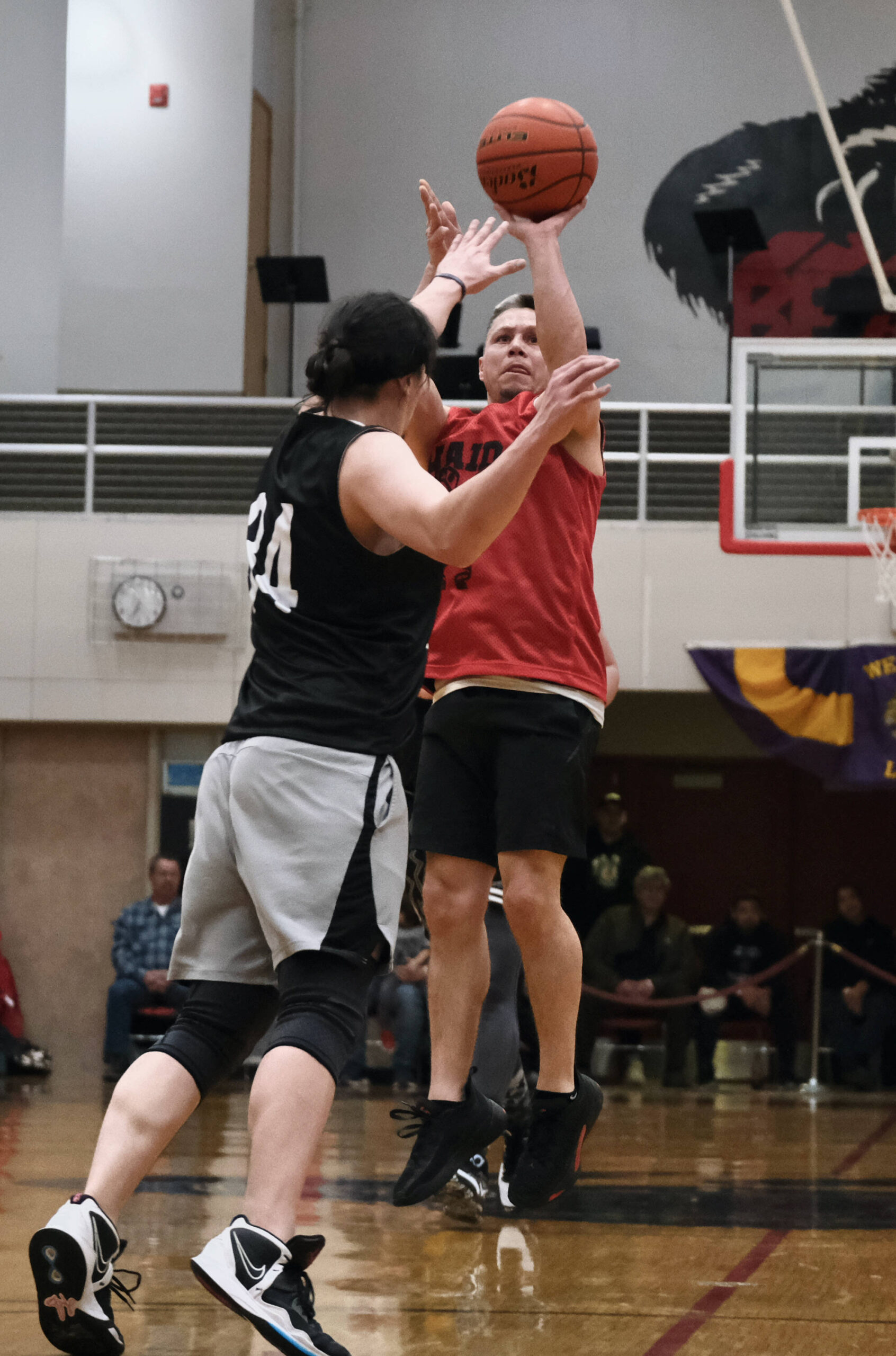Hydaburg’s Vinnie Edenshaw scores over Angoon’s Duncan O’Brien (34) during B Bracket action during the Juneau Lions Club 74th Annual Gold Medal Basketball Tournament, Sunday, March 19, at the Juneau-Douglas High School: Yadaa.at Kalé gymnasium. (Klas Stolpe / For the Juneau Empire)