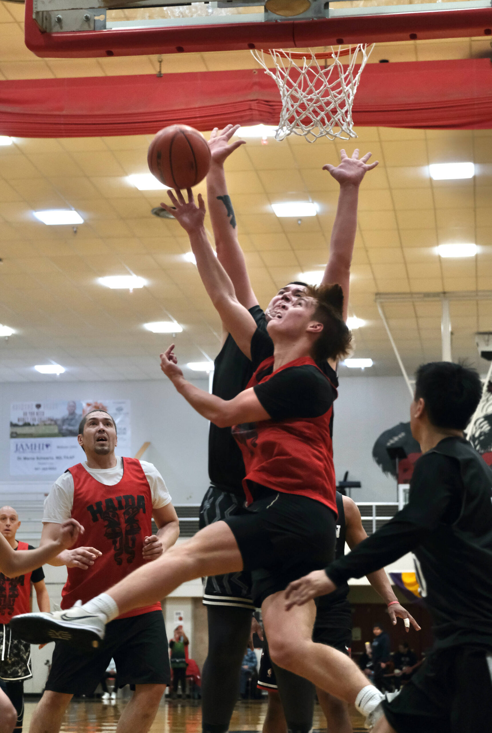 Hydaburg’s Jaren Carle puts a shot up against Angoon’s Kendrick Payton during B Bracket action during the Juneau Lions Club 74th Annual Gold Medal Basketball Tournament, Sunday, March 19, at the Juneau-Douglas High School: Yadaa.at Kalé gymnasium. (Klas Stolpe / For the Juneau Empire)