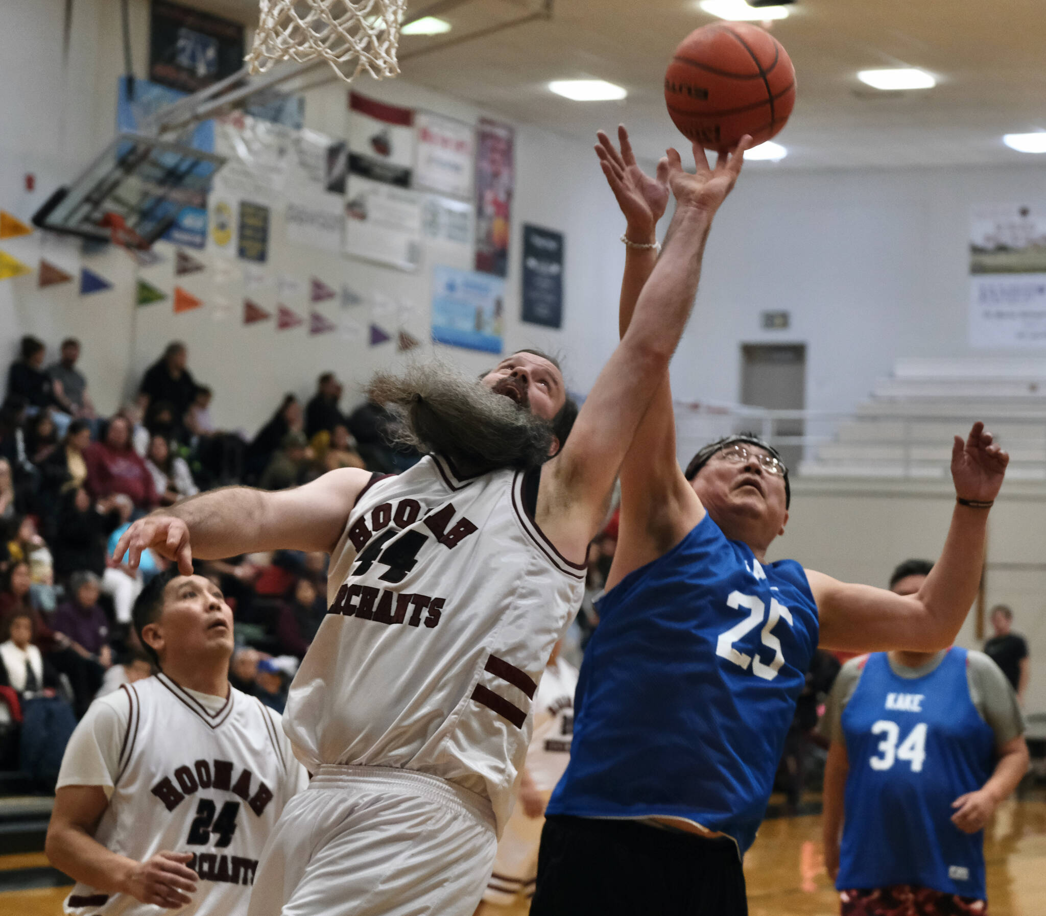 Hoonah’s Mark Prpich (44) battles for a rebound with a Kake player during Masters Bracket action at the Juneau Lions Club 74th Annual Gold Medal Basketball Tournament, Sunday, March 19, at the Juneau-Douglas High School: Yadaa.at Kalé gymnasium. (Klas Stolpe / For the Juneau Empire)