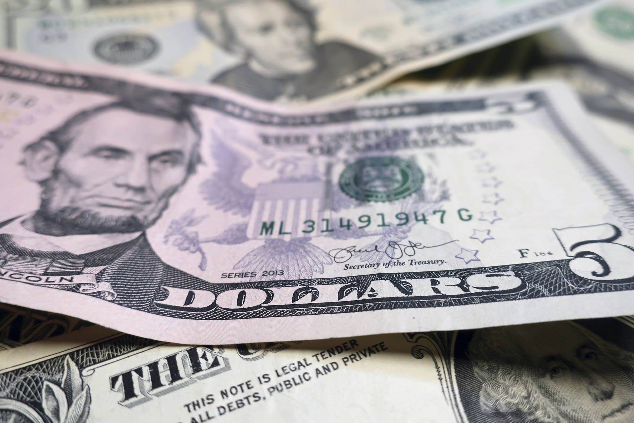 Alaska’s state legislators are slated to get the equivalent of 6,720 additional $5 bills in their salary next year via a $33,600 raise to a total of $84,000 due to a veto Monday by Gov. Mike Dunleavy of bill rejecting raises for legislative and executive branch employees. (AP Photo/Ted Shaffrey, File)