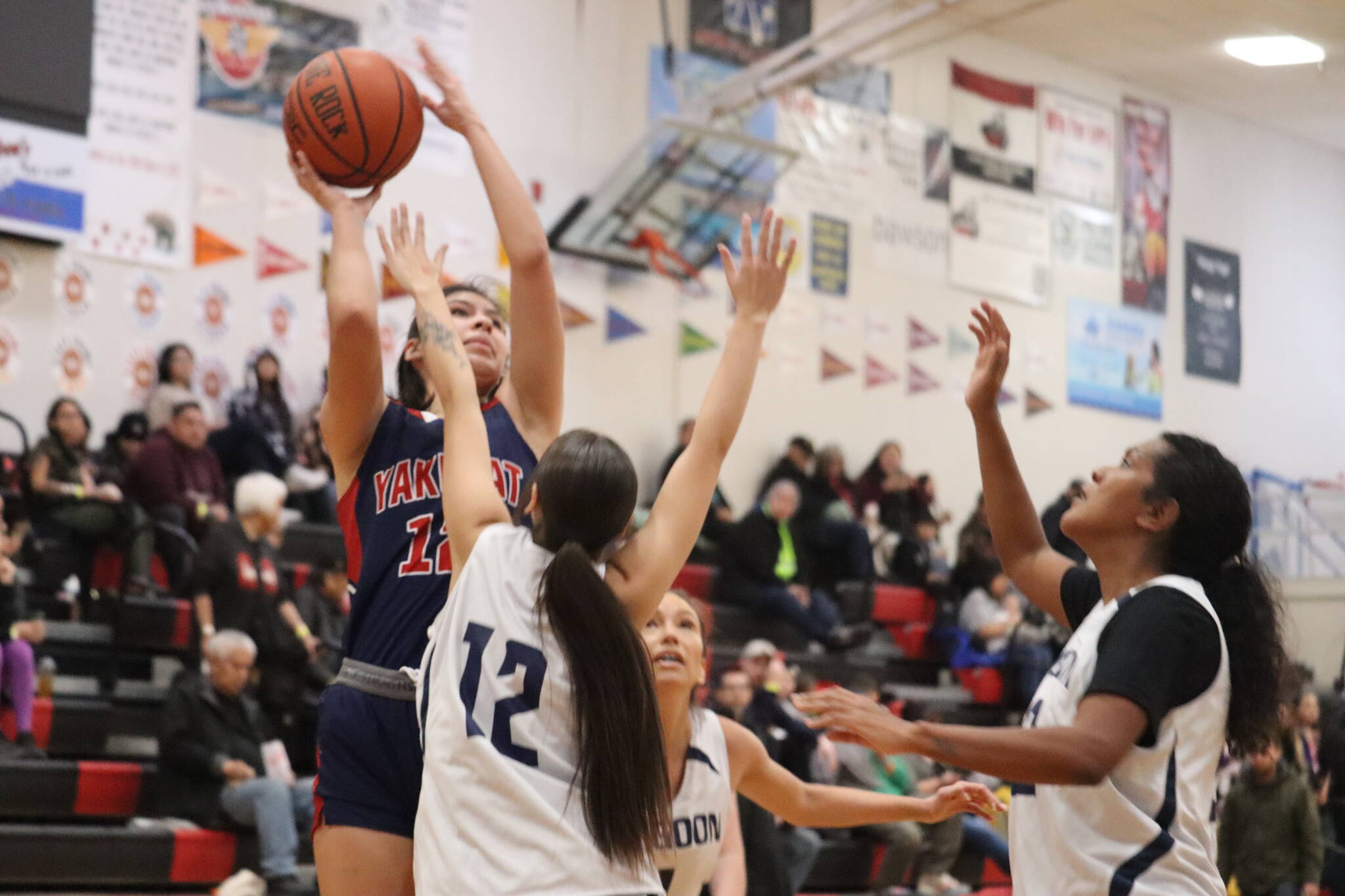 Yakutat’s Trinity Jackson takes a contested shot during a win against Angoon Tuesday for the Gold Medal basketball tournament. Jackson finished the game with a total of 11 points. (Jonson Kuhn / Juneau Empire)