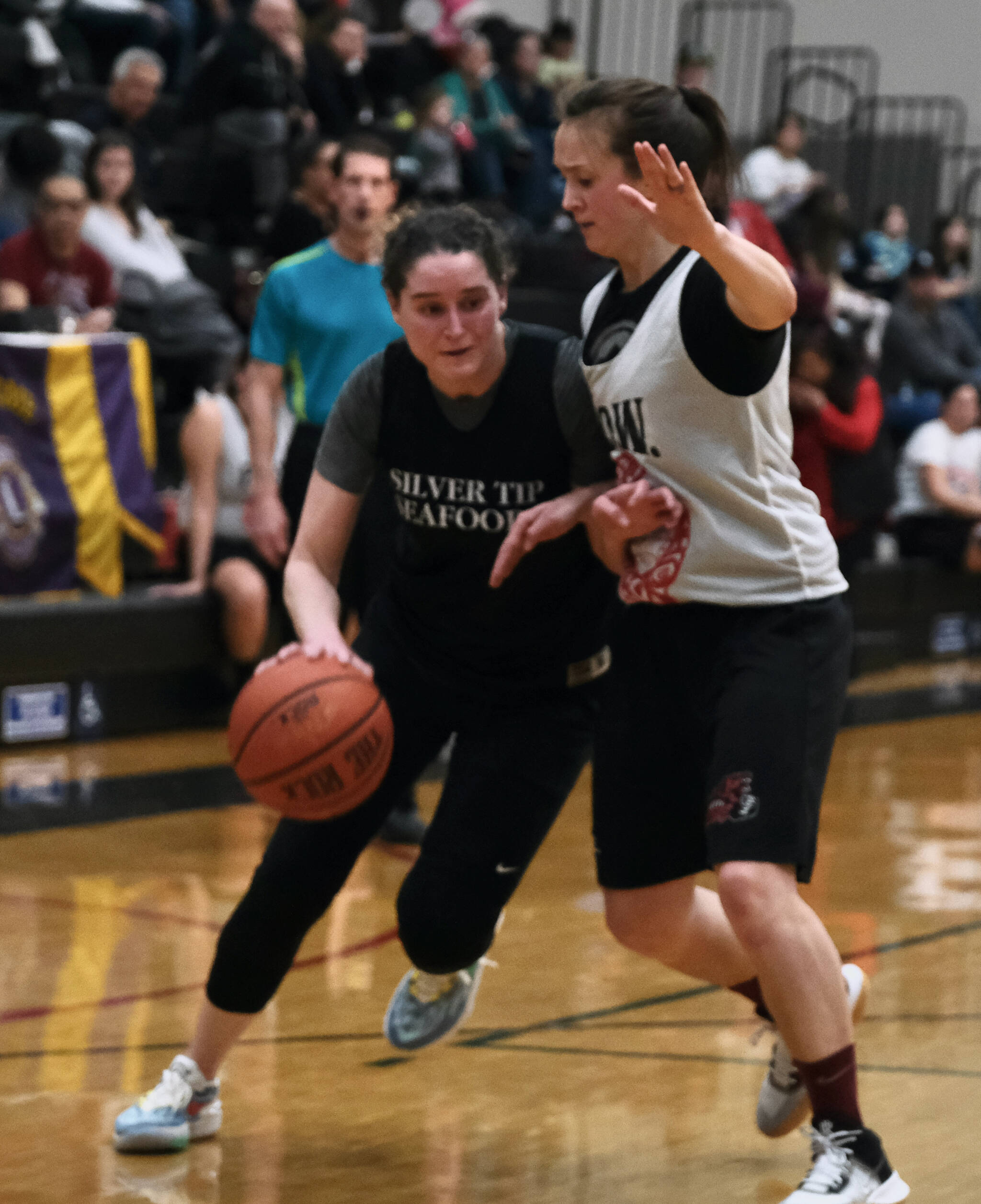 Sitka’s Lexi Smit drives against Prince of Wale’s Nani Weimer at the Gold Medal tournament, Tuesday, March 21, in the Juneau-Douglas High School: Yadaa.at Kalé gymnasium. (Klas Stolpe/For the Juneau Empire)