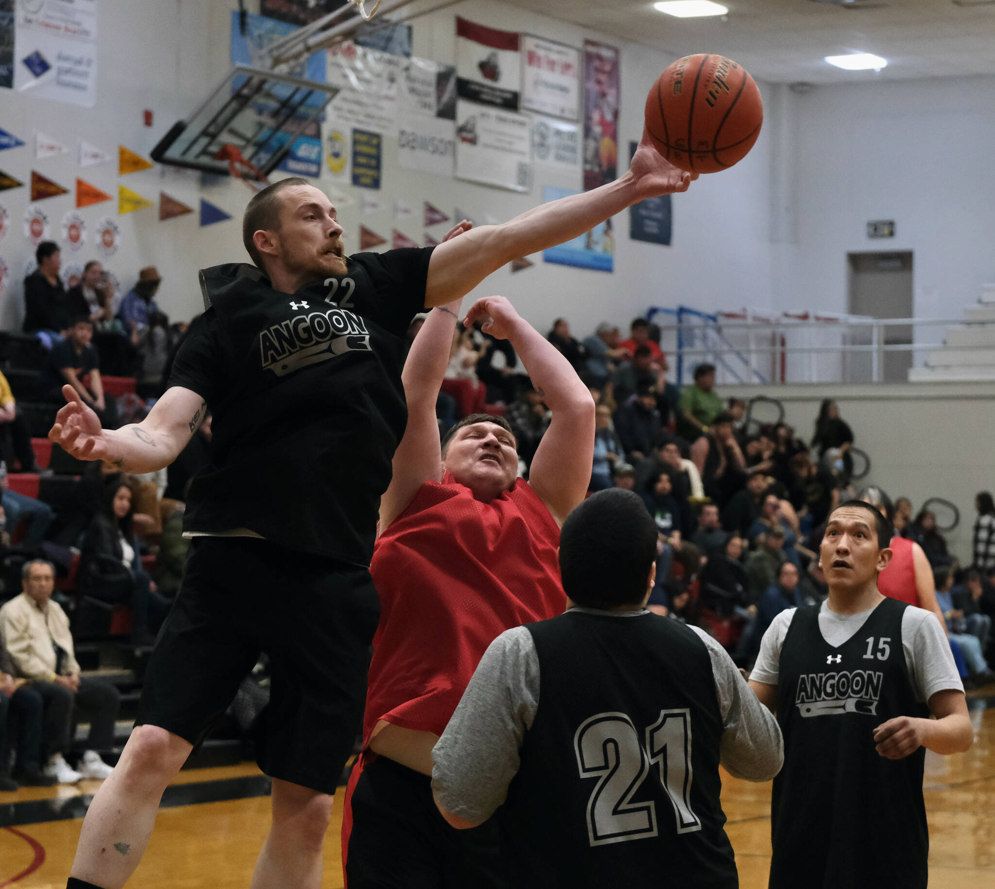 Angoon’s Ivan Raney (22) reaches for a rebound over Kake’s Jess Ross during C Bracket action in the Gold Medal Basketball Tournament, Tuesday, March 21, at Juneau-Douglas High School: Yadaa.at Kalé. (Klas Stolpe / For the Juneau Empire)