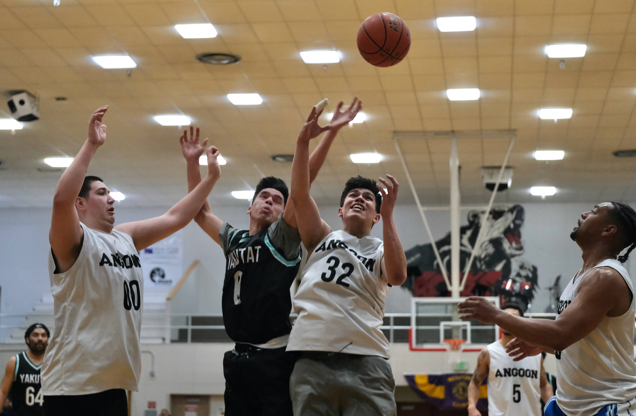 Angoon’s Kendrick Payton (00) and Anthony Snow (32) battle for a rebound with Yakutat’s Josh James (0) during the Gold Medal tournament, Tuesday, March 21, at Juneau-Douglas High School: Yadaa.at Kalé. (Klas Stolpe / For the Juneau Empire)