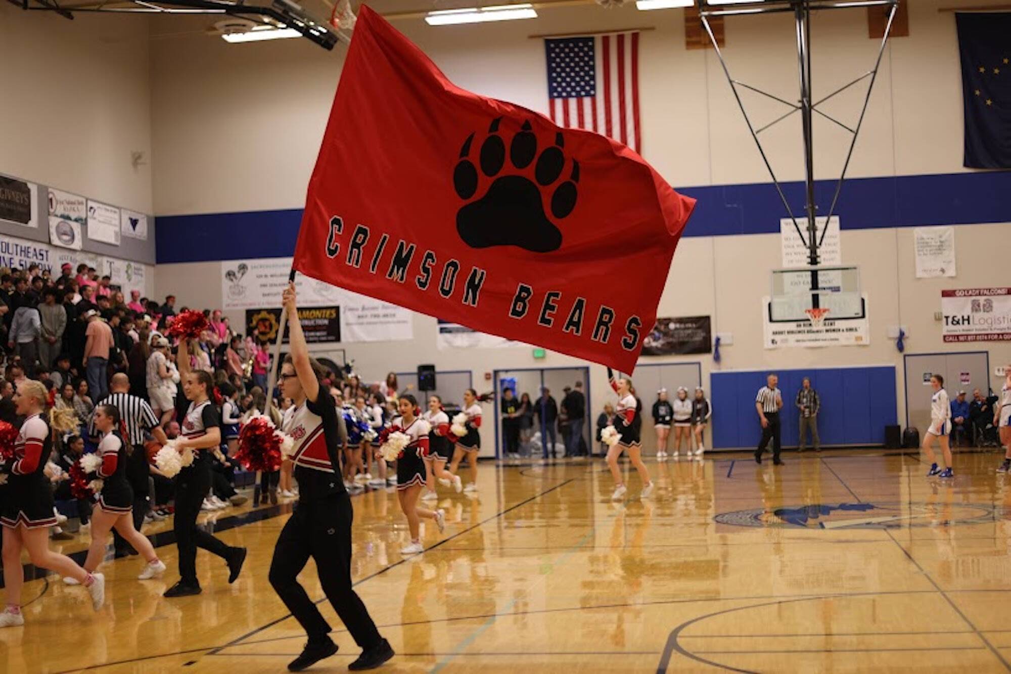 JDHS cheer team leads crowd in chant for the opening of a Crimson Bears Region V basketball game. Winning that tournament sent the JDHS boys to state in Anchorage. They played against top-seeded West Valley High School on Wednesday, losing 60-37 (Ben Hohenstatt / Juneau Empire File)