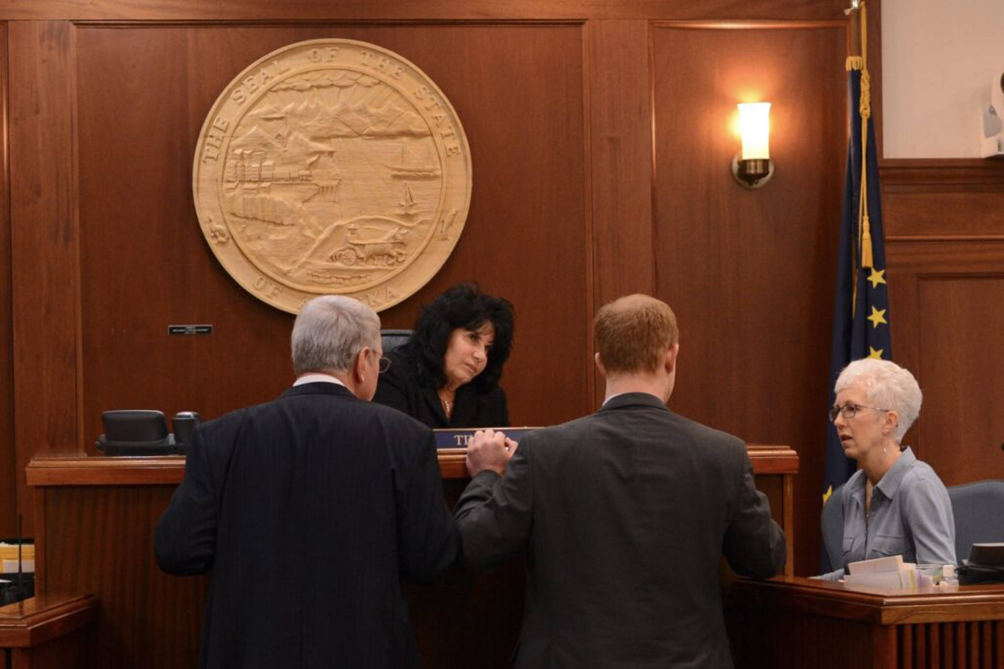 From left to right, House Majority Leader Dan Saddler, R-Eagle River; Speaker of the House Cathy Tilton, R-Wasilla; and Rep. David Eastman, R-Wasilla; listen to House Clerk Kris Jones during a break in the session of the Alaska House of Representatives on Wednesday, March 22, 2023. (Photo by James Brooks / Alaska Beacon)