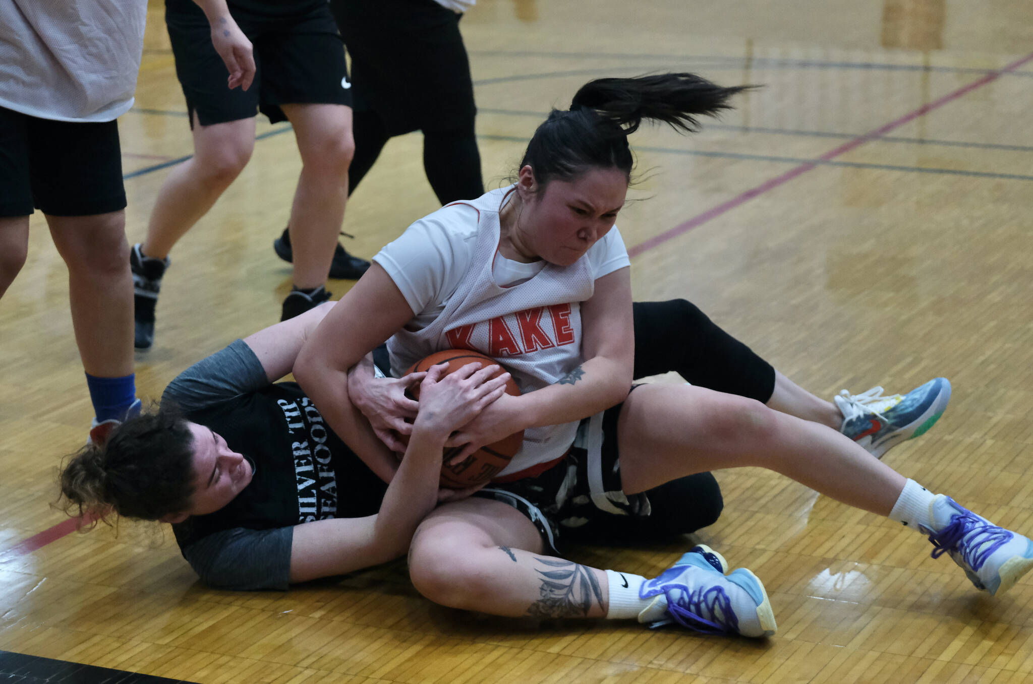 Kake’s Louise Kadake and Sitka’s Lexi Smith battle for a loose ball during the Gold Medal tournament, Wednesday, March 22, at Juneau-Douglas High School: Yadaa.at Kalé. (Klas Stolpe/For the Juneau Empire)