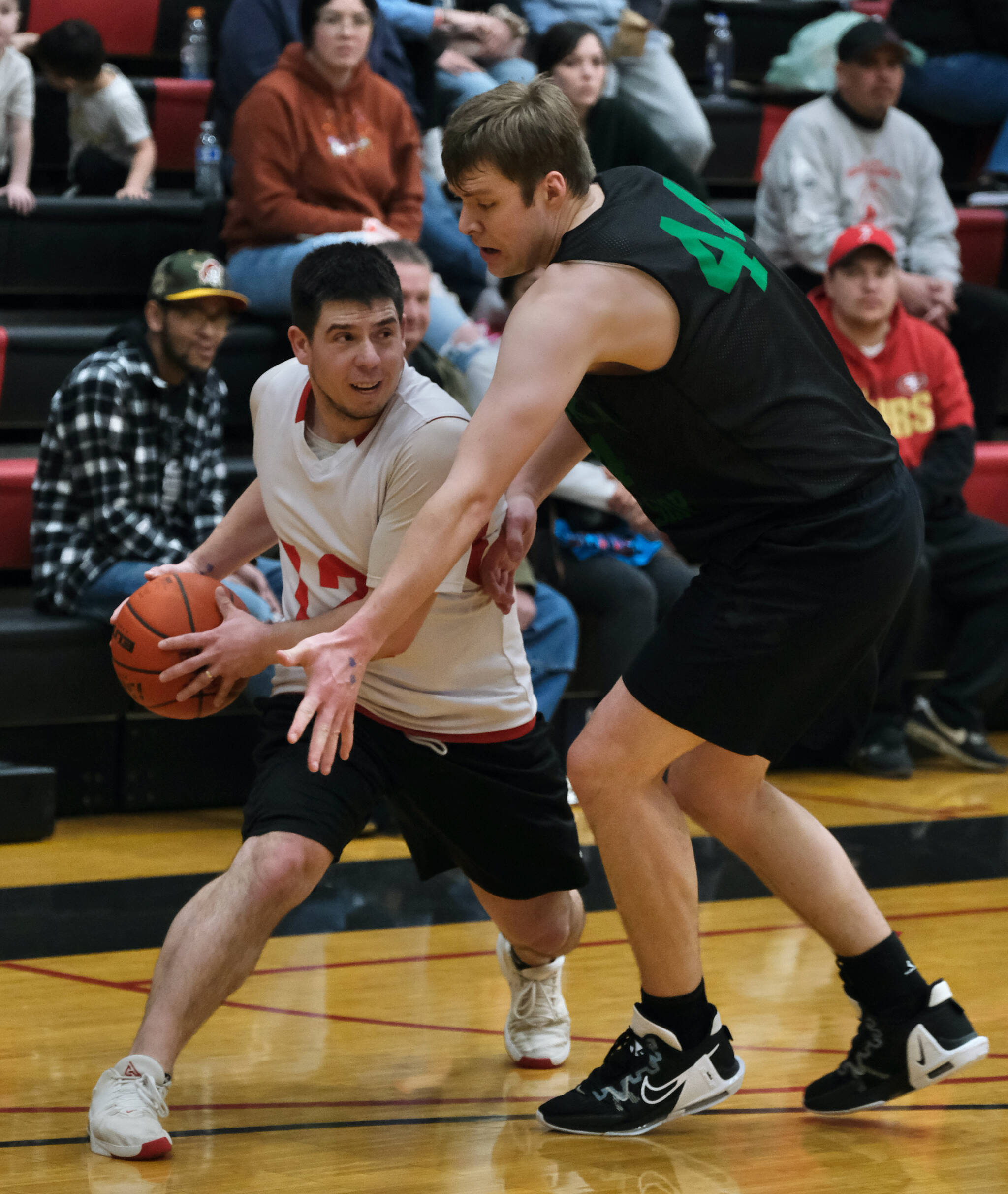 Kake’s Tracy Jackson looks to pass around the defense of Haines’ Tyler Swinton during the Gold Medal tournament, Wednesday, March 22, at Juneau-Douglas High School: Yadaa.at Kalé. (Klas Stolpe/For the Juneau Empire)