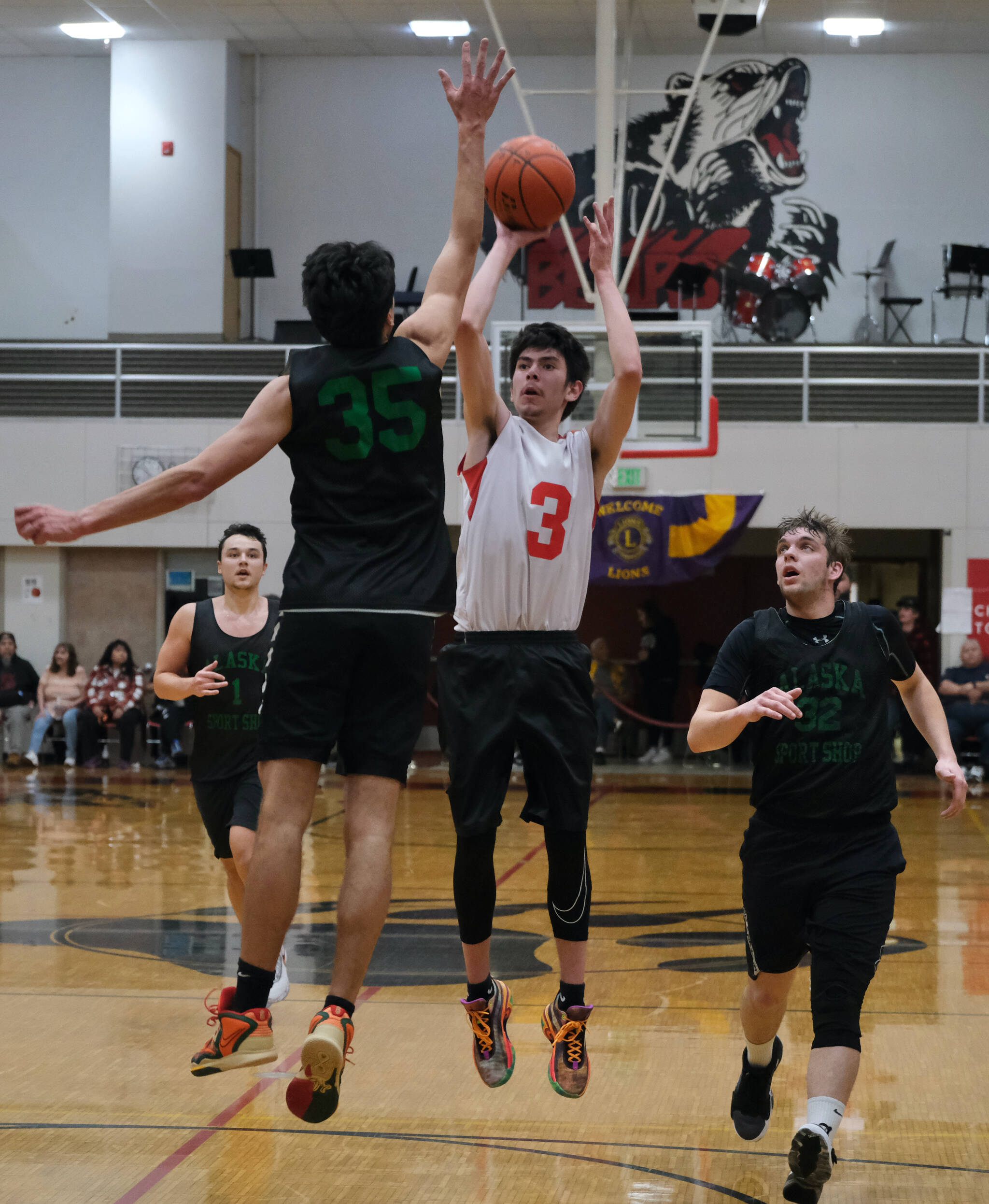 Kake’s Shawn Merry (3) is defended by Haines’ Kirby Faverty (35) as Haines’ Kai Sato-Franks (1) and Dylan Swinton (32) look on during the Gold Medal tournament, Wednesday, March 22, at Juneau-Douglas High School: Yadaa.at Kalé. (Klas Stolpe/For the Juneau Empire)