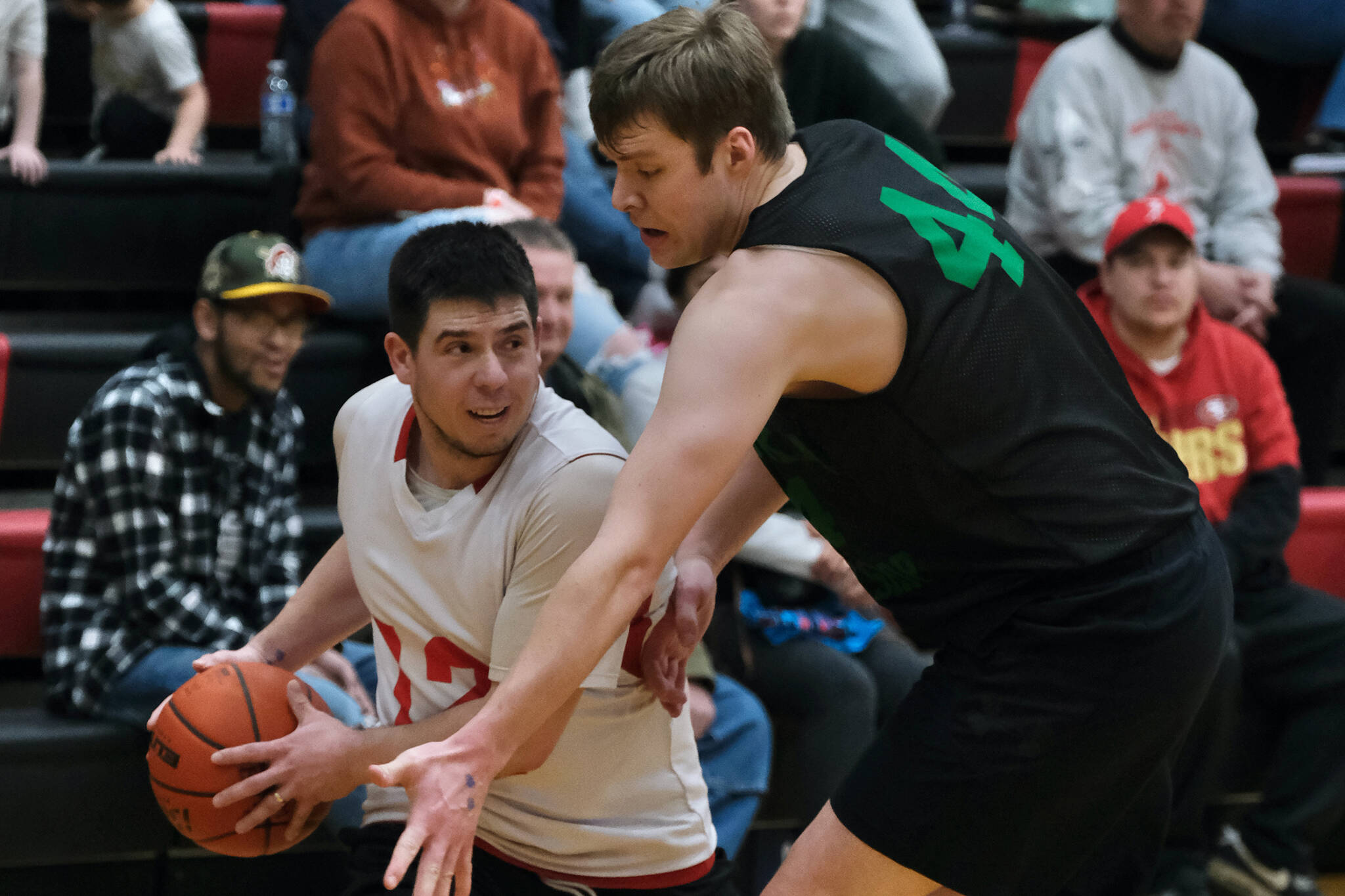 Kake's Tracy Jackson looks to pass around the defense of Haines' Tyler Swinton during the Gold Medal tournament, Wednesday, March 22, at Juneau-Douglas High School: Yadaa.at Kalé. (Klas Stolpe/For the Juneau Empire)