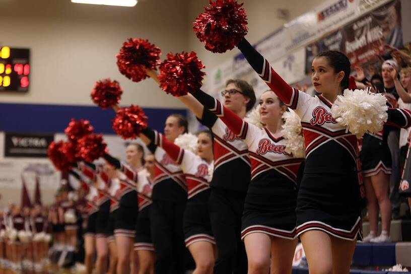 The JDHS cheer team puts paws up for a free throw shot during a Crimson Bears Region V 4A Tournament game. JDHS cheer team is celebrating its third state championship title in a row after competing in Anchorage on Tuesday. From front to back, Angelina Hammons, Summer Lucas, Reuben Grimes, Emily Delgado, Ryan Shattuck, Mila Griffin and Emma Busby. (Ben Hohentstatt / Juneau Empire File)