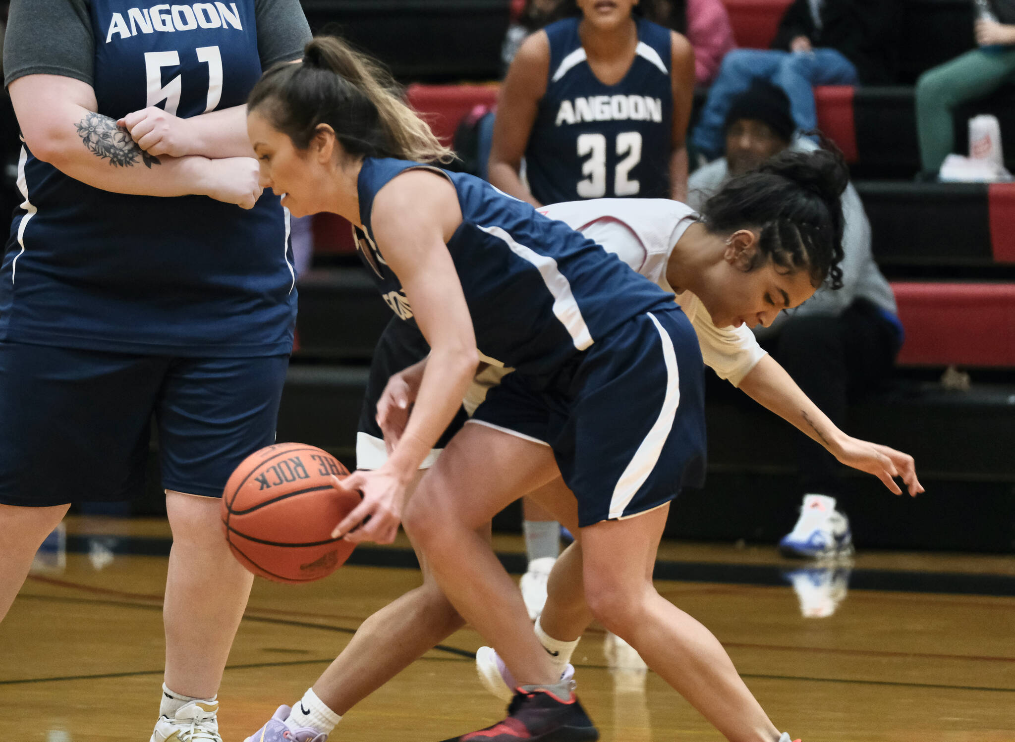 Angoon’s Carmeleeda Estrada is pressured by Kake’s Willow Jackson during Thursday action at the Juneau Lions Club 74th Annual Gold Medal Basketball Tournament at Juneau-Douglas High School: Yadaa.at Kalé. (Klas Stolpe/For the Juneau Empire)