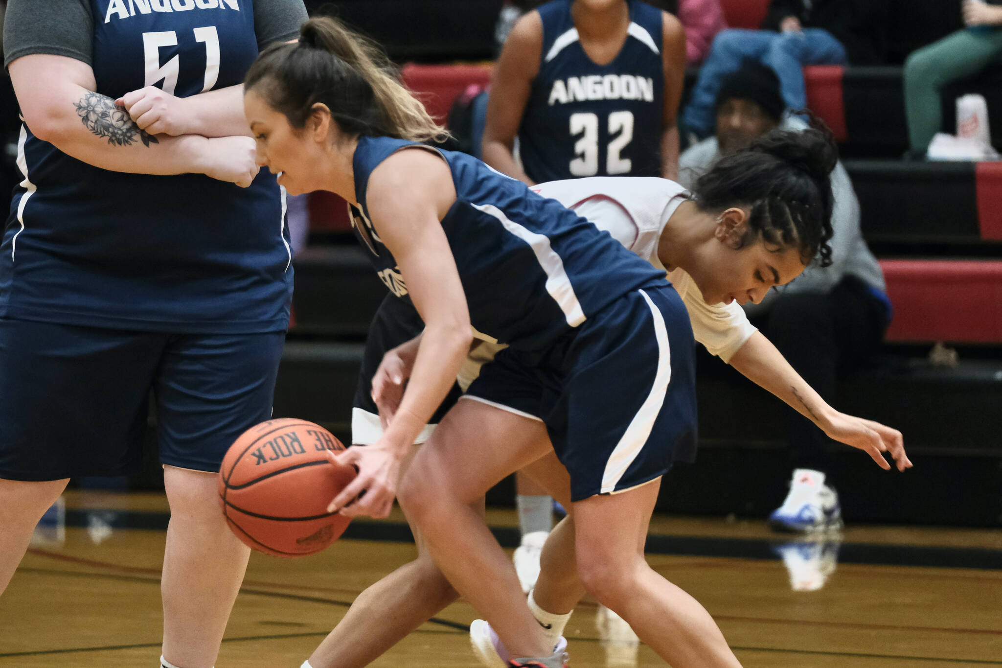 Angoon's Carmeleeda Estrada is pressured by Kake's Willow Jackson during Thursday action at the Juneau Lions Club 74th Annual Gold Medal Basketball Tournament at Juneau-Douglas High School: Yadaa.at Kalé. (Klas Stolpe/For the Juneau Empire)