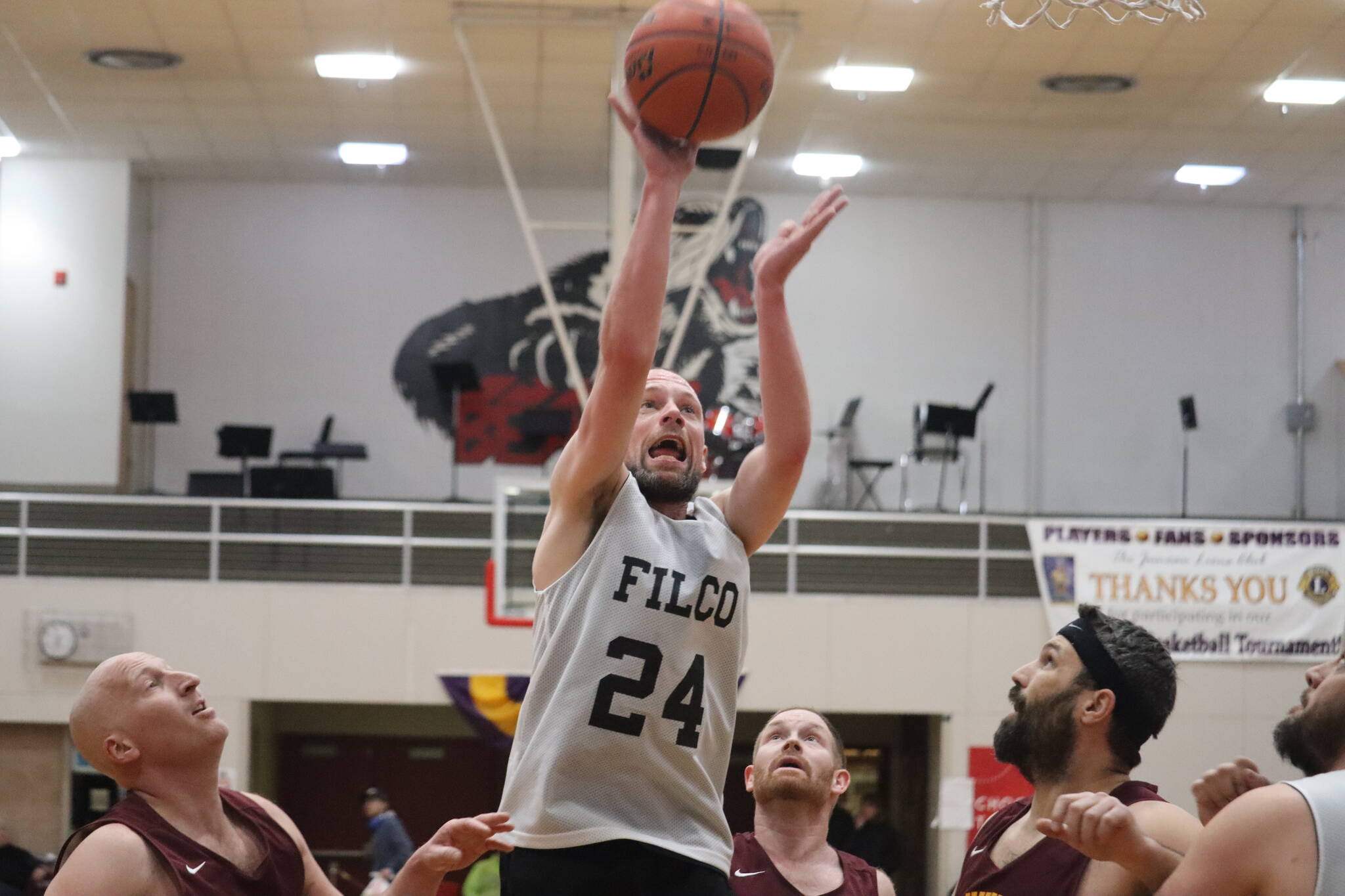 Filcom’s Alex Heumann (24) puts up a jump shot against Klukwan on Thursday for the second C bracket game of the day in this year’s Gold Medal basketball tournament. Heumann finished the game with 27 points, and his team netted a C Bracket win. (Jonson Kuhn / Juneau Empire)