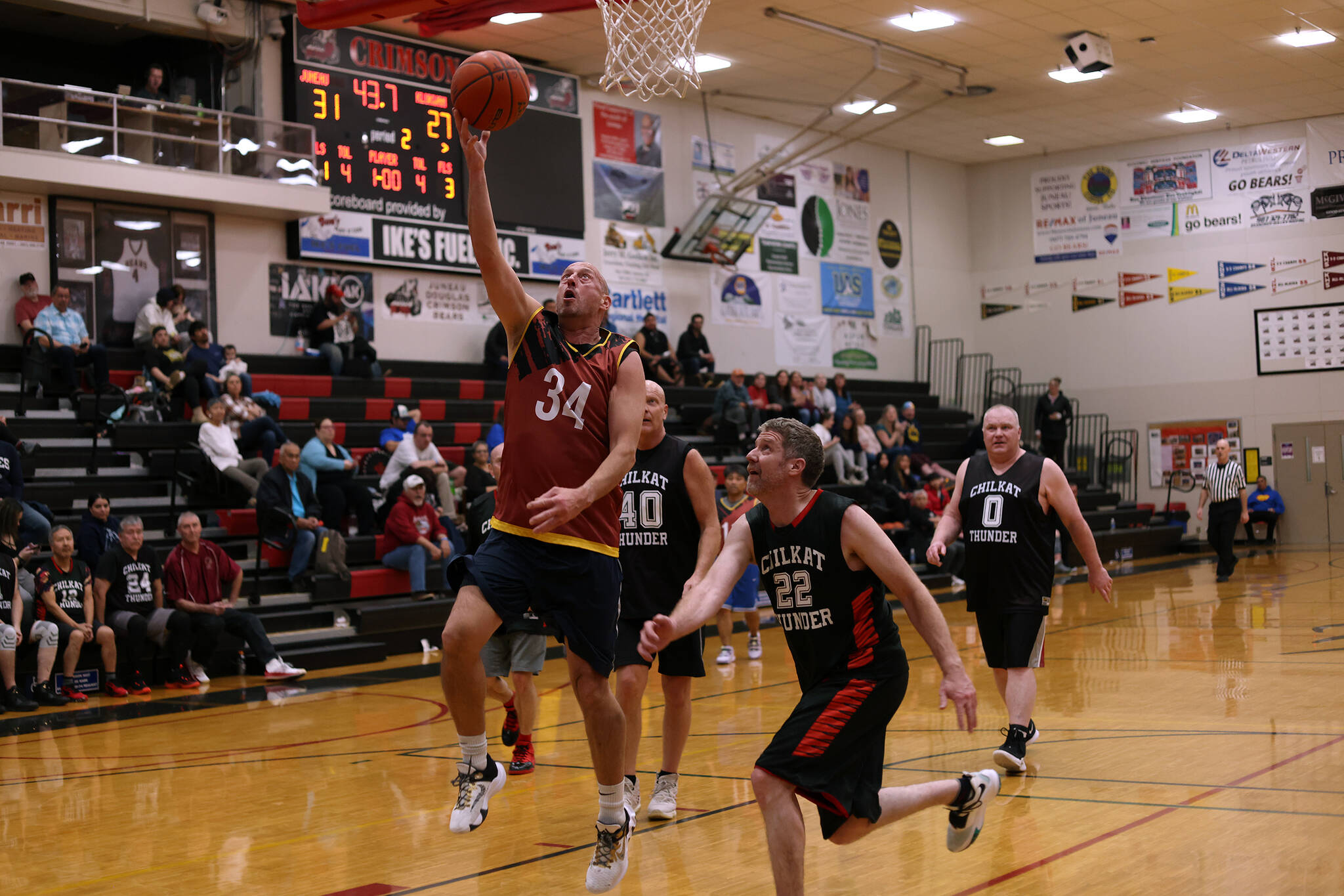 Daylight Saving Time just started, but Juneau’s Jim Carson (34) turned back the clock late in the second quarter of a Masters Bracket game against Klukwan. Carson finished the Thursday night contest with 16 points, and Juneau prevailed 48-39. (Ben Hohenstatt / Juneau Empire)