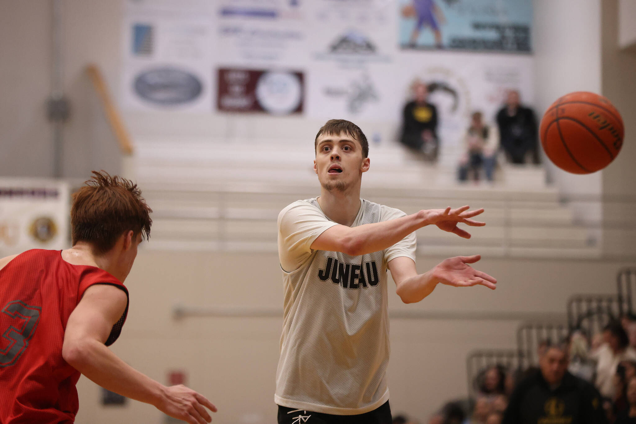 Kaleb Tompkins throws a no-look pass in the second half of a Juneau-Hydaburg B Bracket game on the fifth day of the Gold Medal Basketball Tournament.
