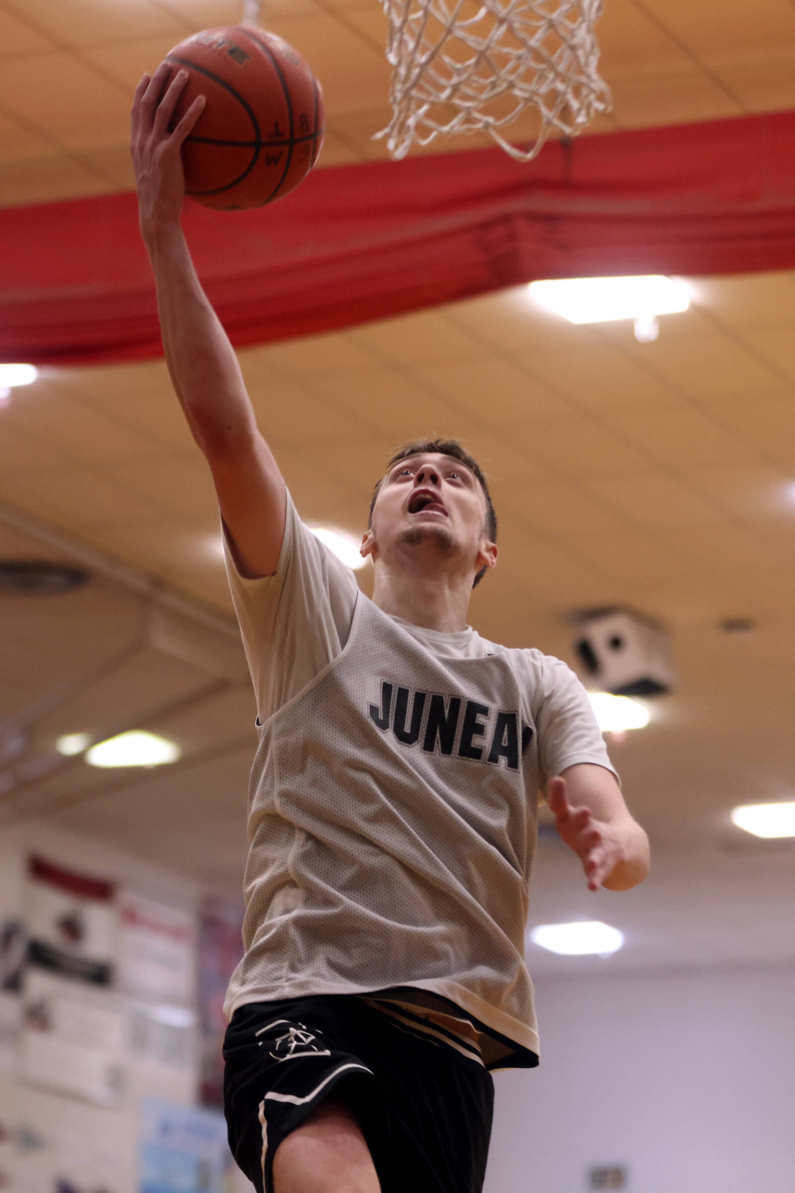 Juneau’s Kaleb Tompkins rises for an uncontested layup during a Thursday night Juneau B Bracket win over Hydaburg. Tompkins finished the night with 20 points, which paced his team. (Ben Hohenstatt / Juneau Empire)