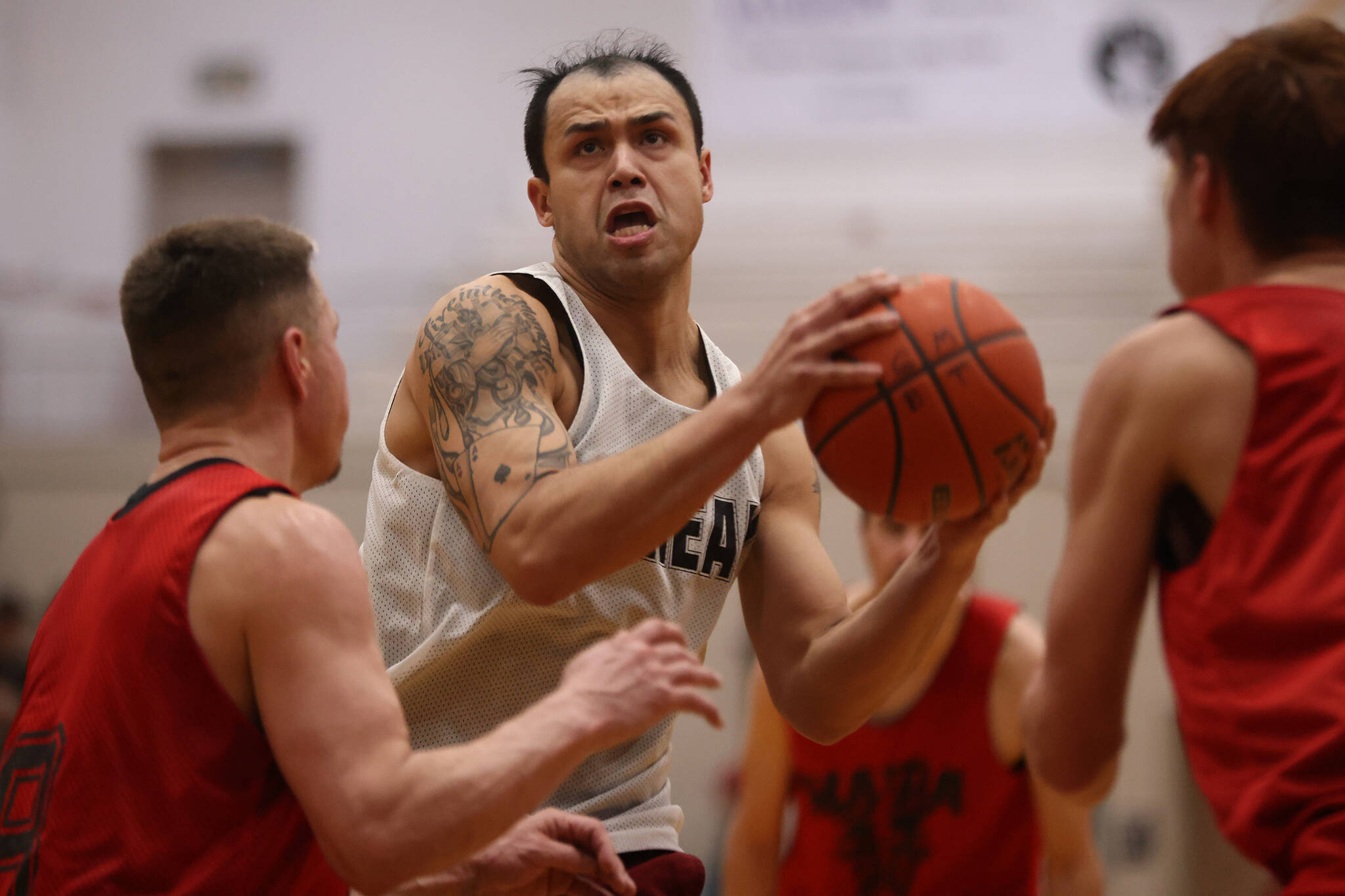 Juneau’s Terrence Wheat drives to the hoop late in a Juneau B Bracket win against Hydaburg. The Thursday night win punched Juneau’s ticket to the B Bracket championship game on Saturday. (Ben Hohenstatt / Juneau Empire)