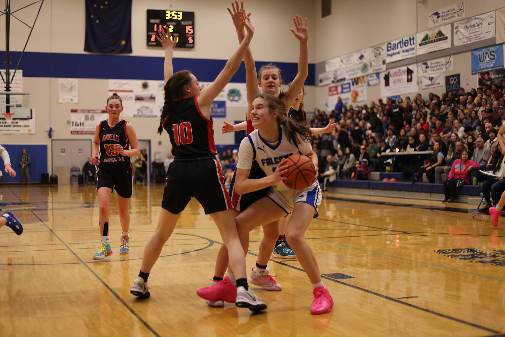 TMHS Kerra Baxter fights for the rebound against JDHS during Region V tournament play. The Lady Falcons won their game on Friday against Dimond in Anchorage as part of this year’s ASAA competition. TMHS will now face off against JDHS on Saturday. (Ben Hohenstatt / Juneau Empire File)