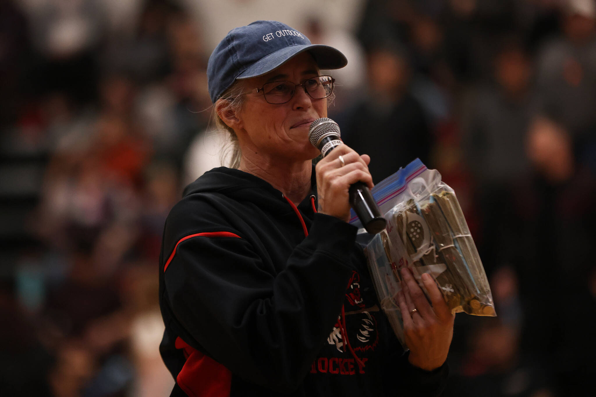 Molly Box, interim principal for Juneau School District’s Tlingit Culture Language and Literacy Program, accepts over $2,500 that was raised prior to Thursday night’s B Bracket game. (Ben Hohenstatt / Juneau Empire)