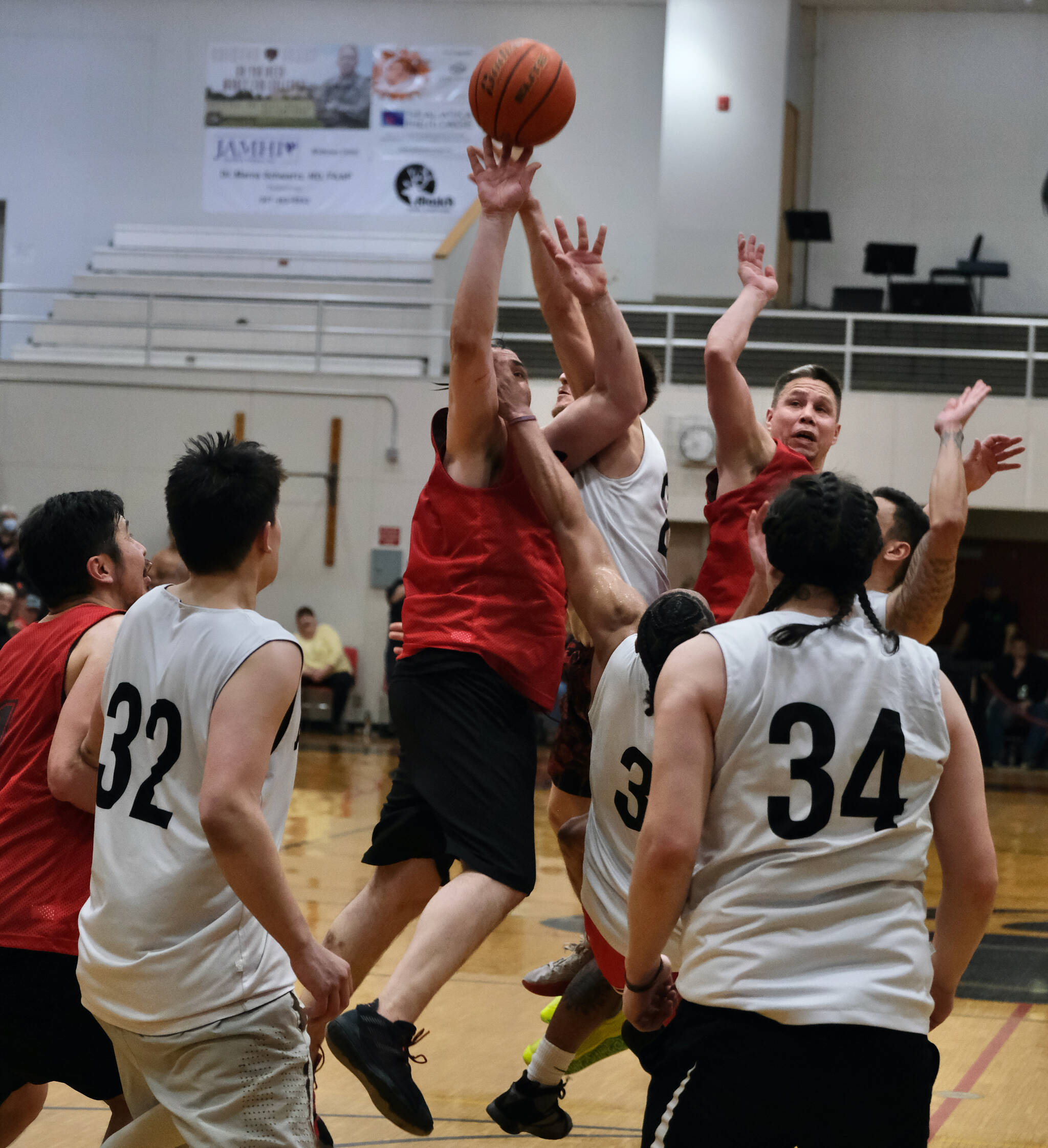 Hydaburg’s George Peratrovich tips in teammate Vinnie Edenshaw’s missed free throw with 0.3 seconds remaining in overtime, forching a second overtime in a win over Angoon during Friday night’s elimination game at the Gold Medal Tournament in Juneau. (Klas Stolpe/For the Juneau Empire)