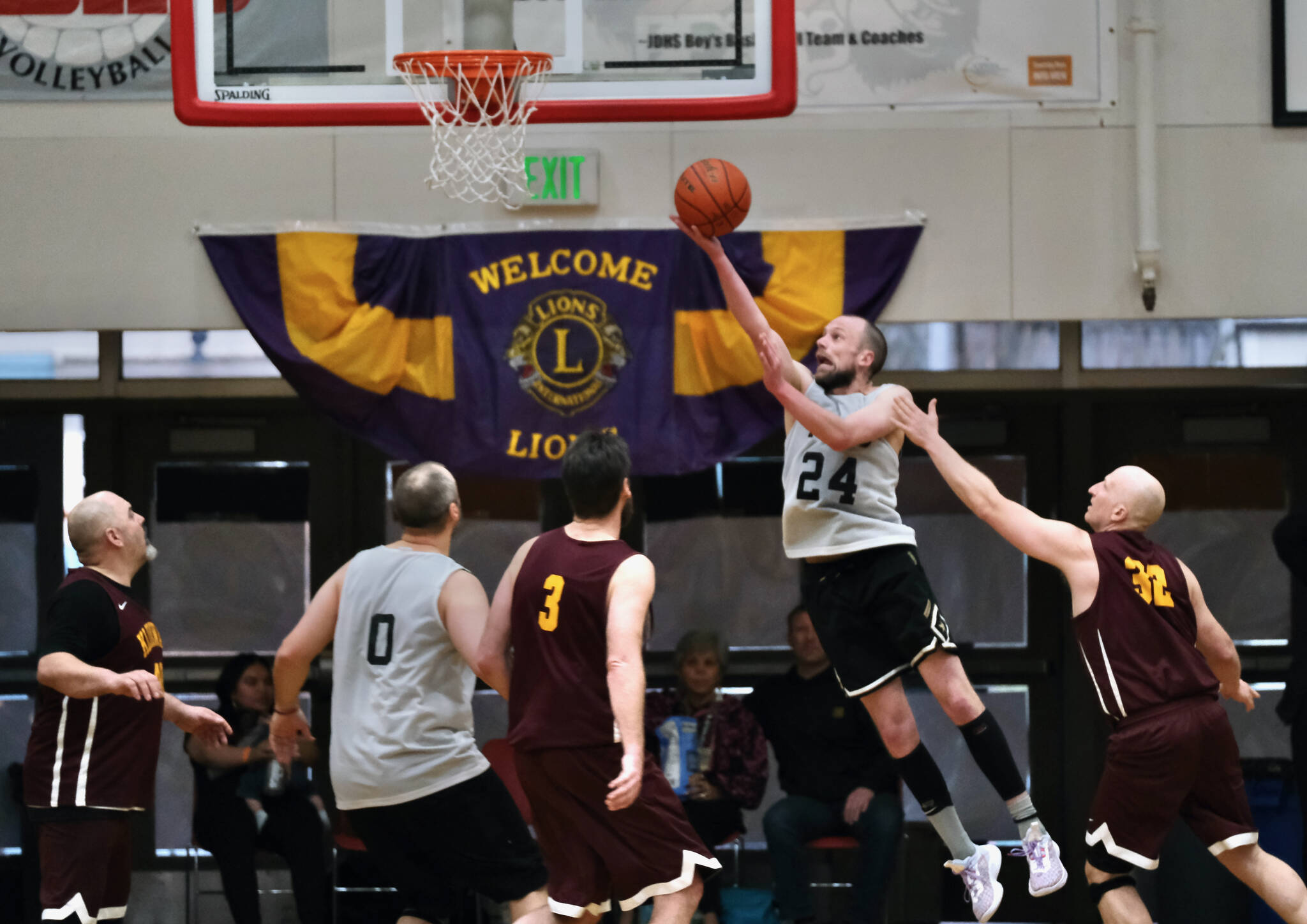 Filcom’s Alex Heumann (24) scores past Klukwan’s Paul Carrington (3) and Brian Friske (32) during the C Bracket Championship game of the Gold Medal Basketball Tournament, Saturday, March 25, at Juneau-Douglas High School: Yadaa.at Kalé. (Klas Stolpe/For the Juneau Empire)