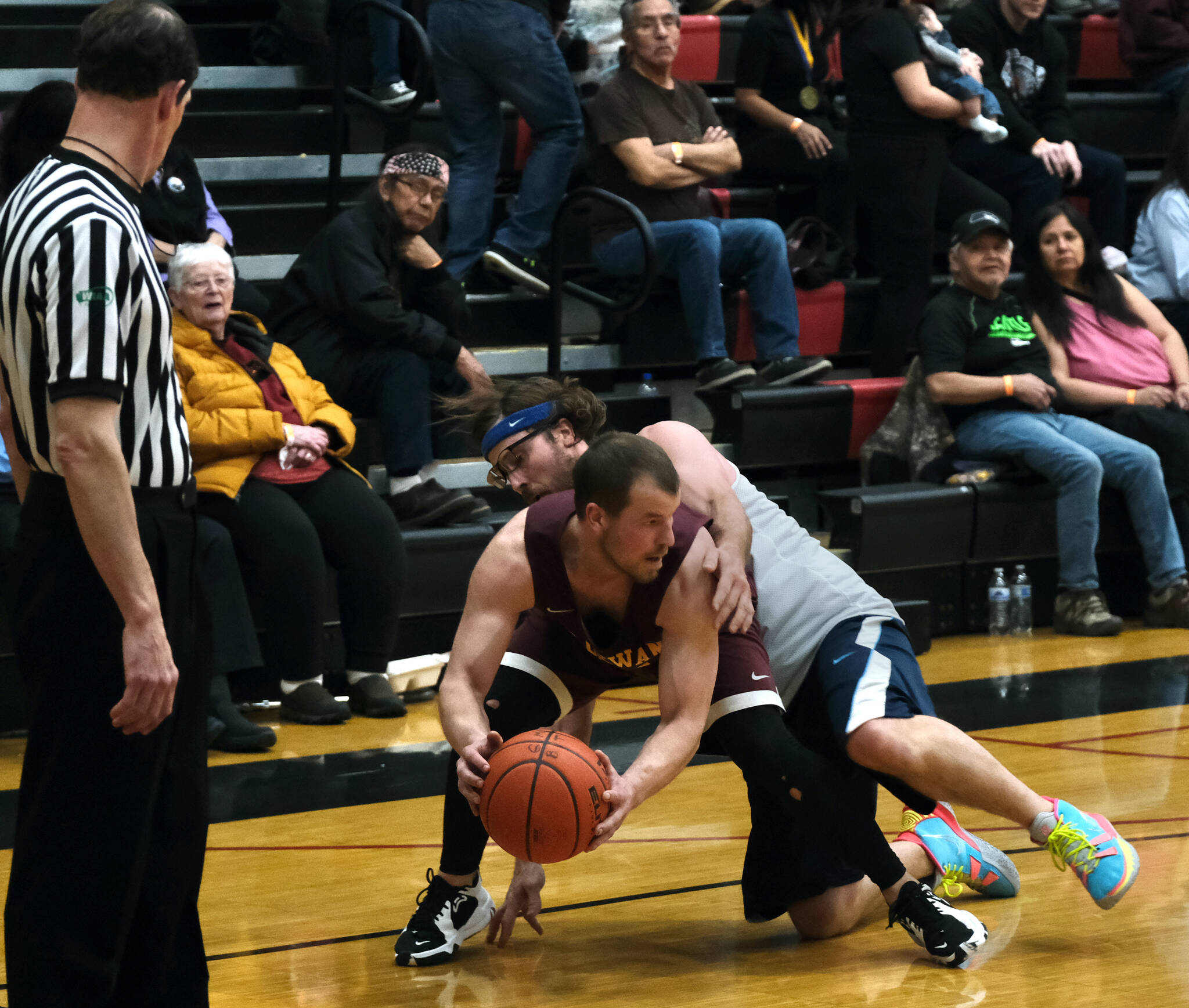 Klukwan’s Bryan Combs is fouled by Filcom’s Adam Brown during the C Bracket Championship game of the Gold Medal Basketball Tournament, Saturday, March 25, at Juneau-Douglas High School: Yadaa.at Kalé. (Klas Stolpe/For the Juneau Empire)