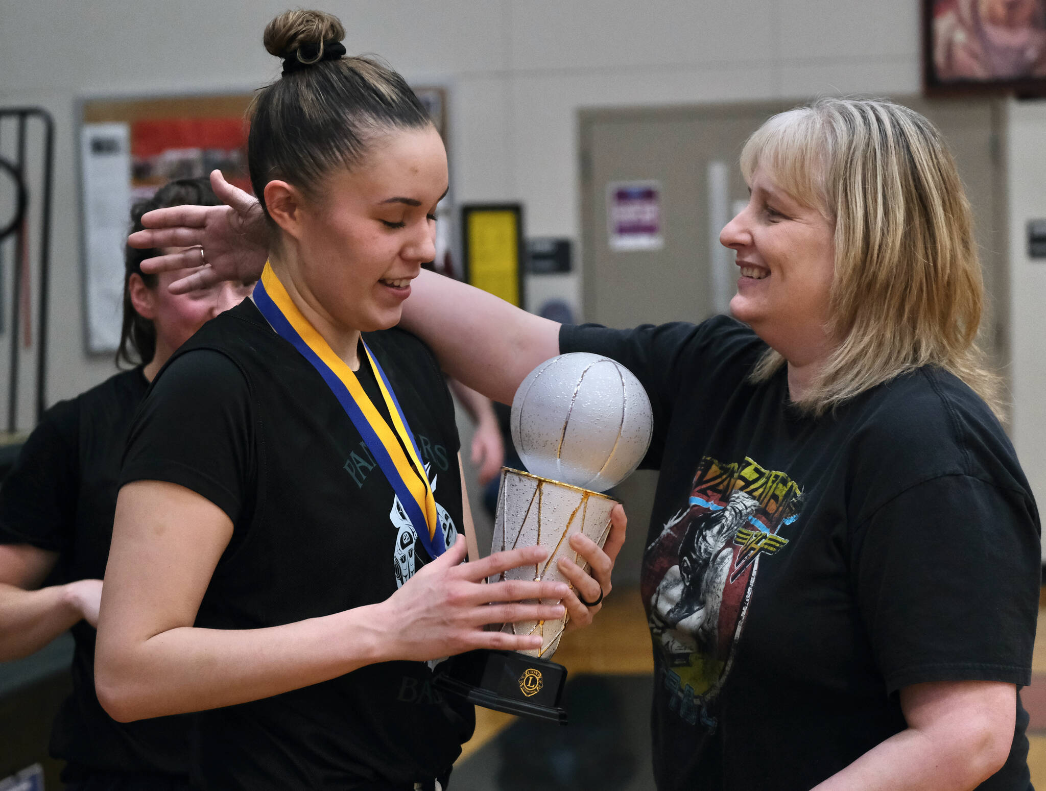 Cassie Williams is congratulated by her mother Ann after winning the Women’s Bracket championship and Most Valuable Player honors, Saturday, March 25, during the Gold Medal Basketball Tournament at Juneau-Douglas High School: Yadaa.at Kalé. (Klas Stolpe/For the Juneau Empire)
