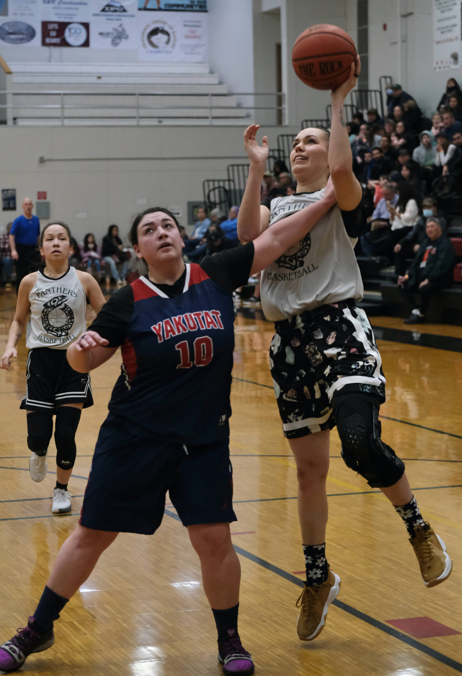 Pow’s Cassie Williams is fouled by Yakutat’s Nadine Fraker (10) in the Women’s Championship game of the Gold Medal Basketball Tournament, Saturday, March 25, at Juneau-Douglas High School: Yadaa.at Kalé. (Klas Stolpe/For the Juneau Empire)